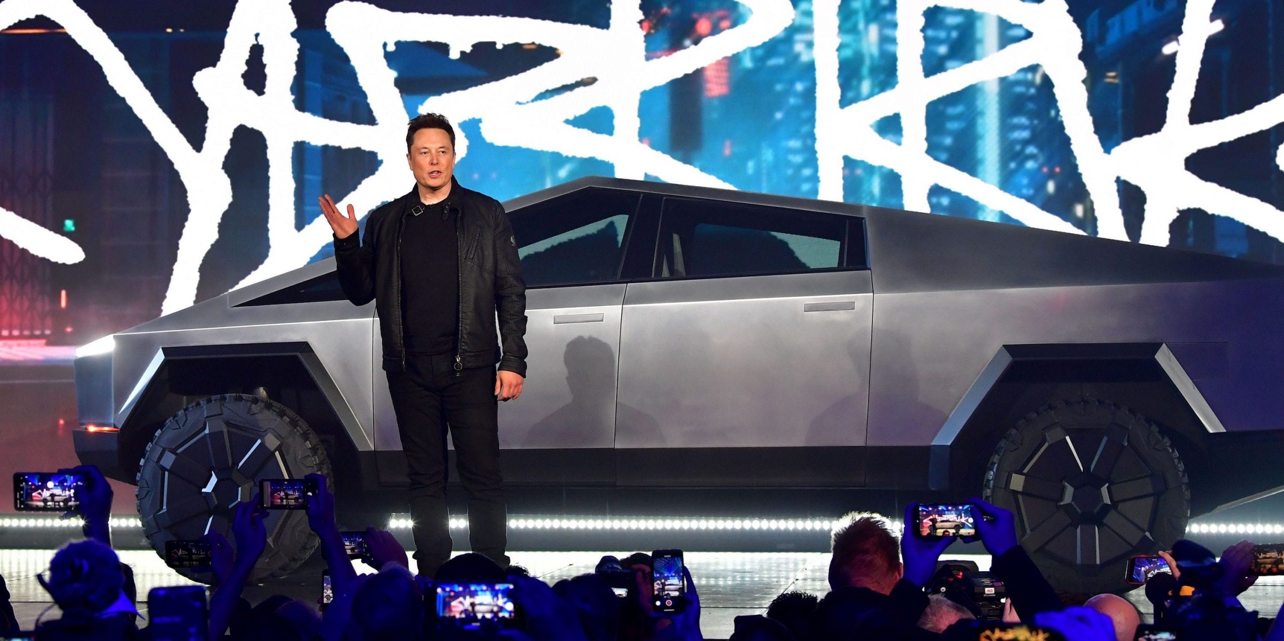 Tesla CEO Elon Musk stands in front of the company's Cybertruck.