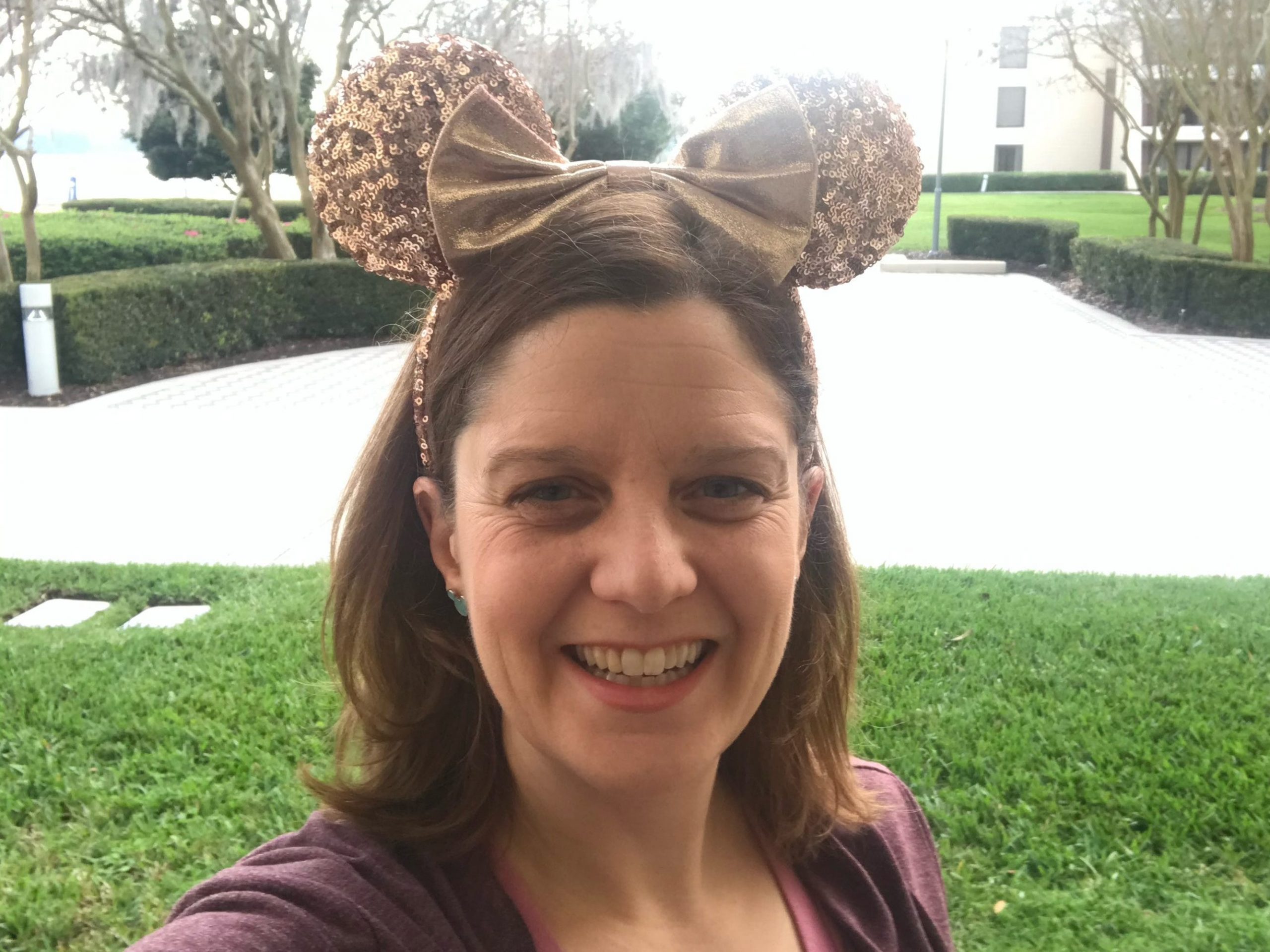 kari becker at disney resort wearing minnie ears