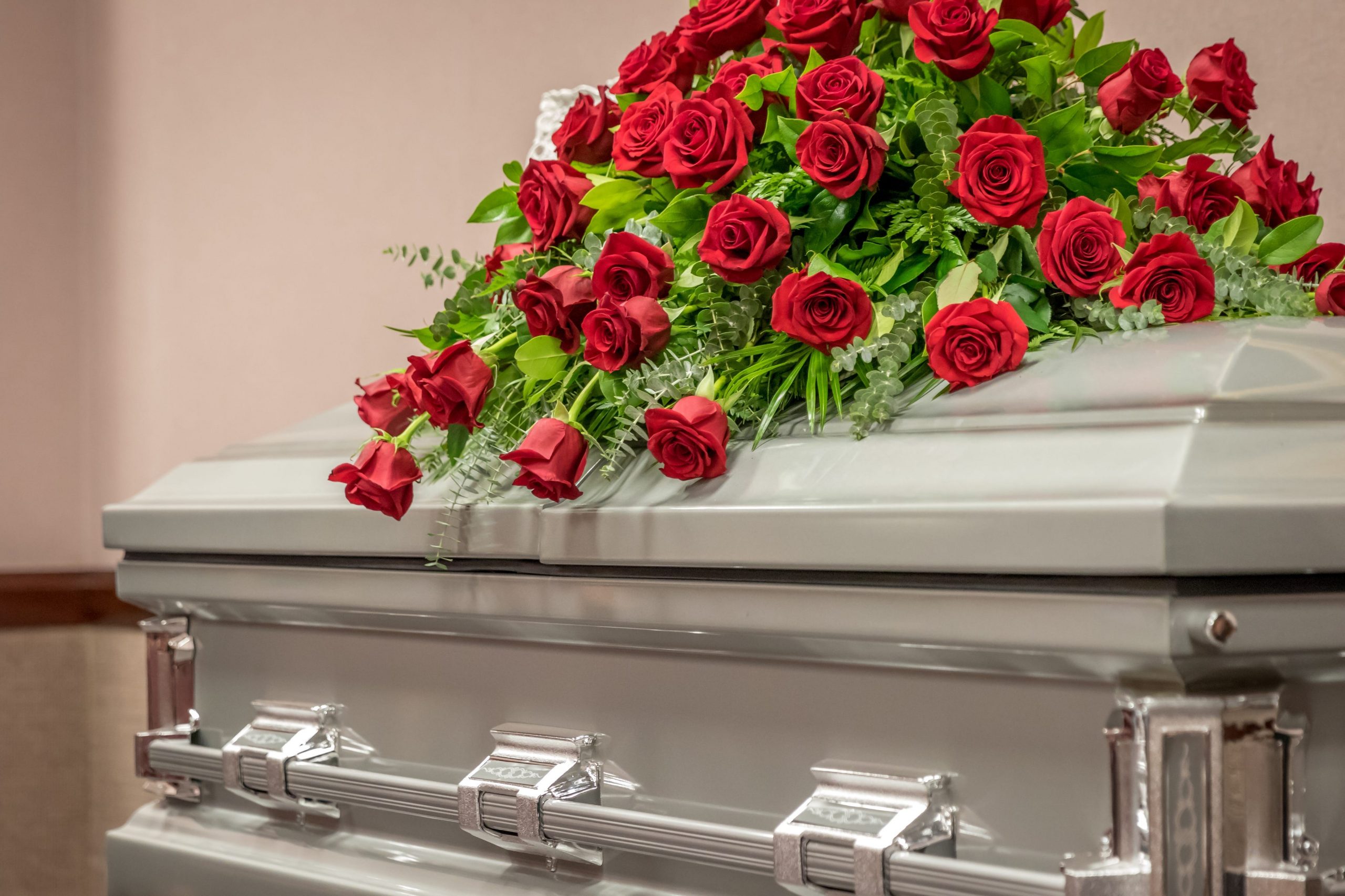 roses on a casket at a funeral