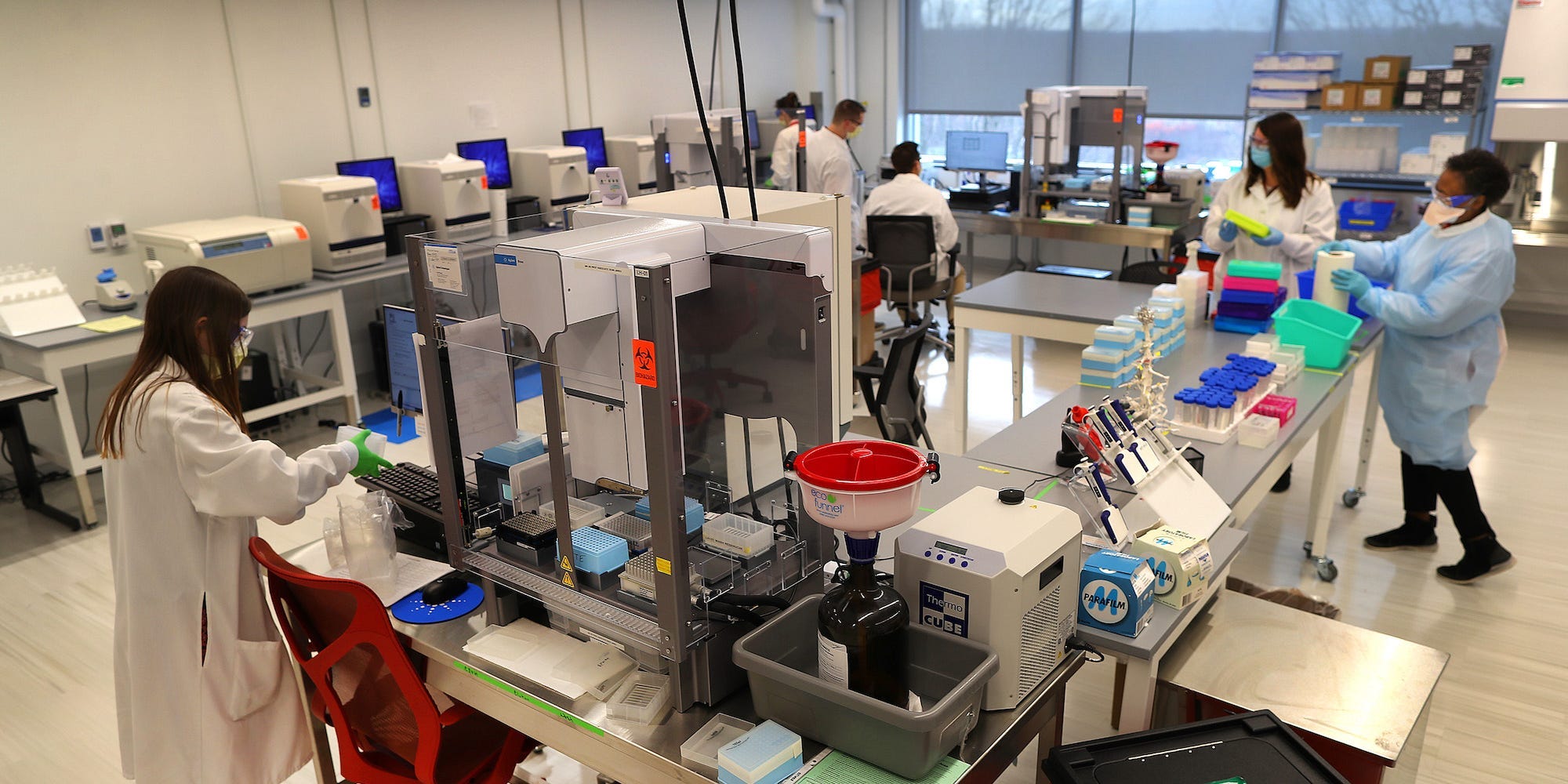 Clinical lab techs work in one of the labs to process the samples from students at a Northeastern University facility in Burlington, MA on Nov. 25, 2020.