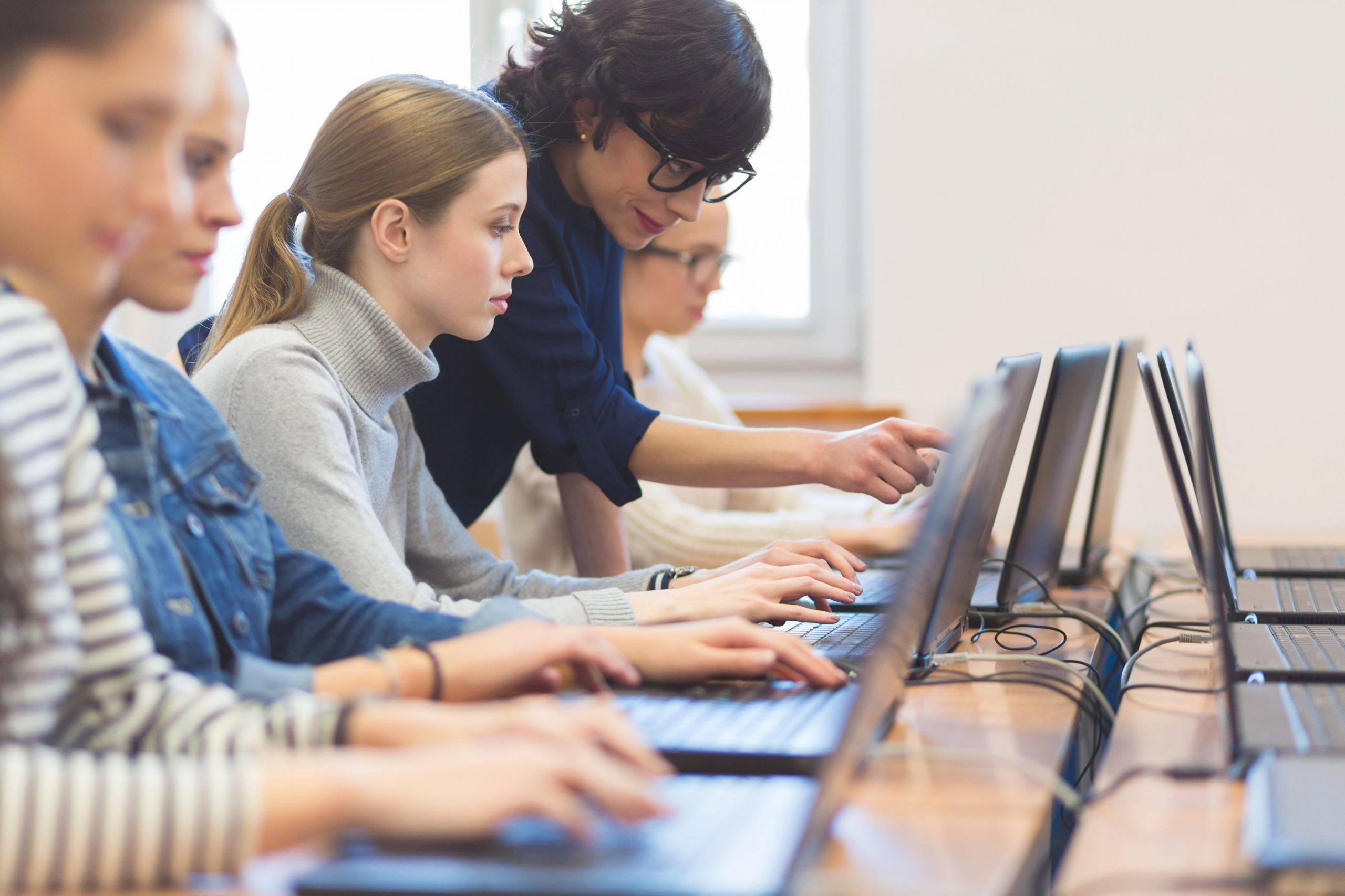 Female students learning from a computer