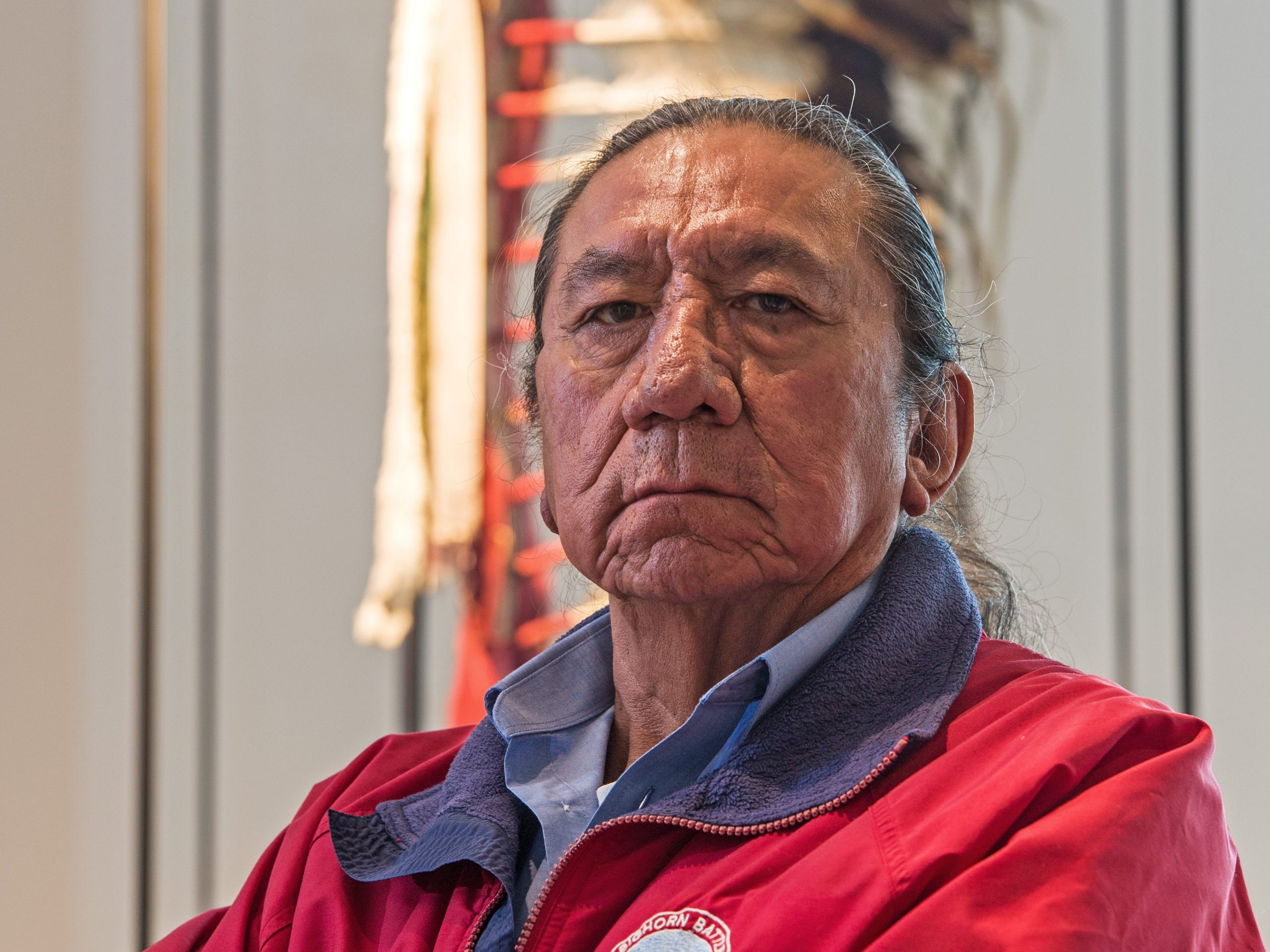 Ernie LaPointe, great-grandson of the legedary chief 'Sitting Bull,' stands in front of the war bonnet from chief 'Red Eagle' at the Uebersee Museum Bremen in Bremen, Germany, 03 November 2016.