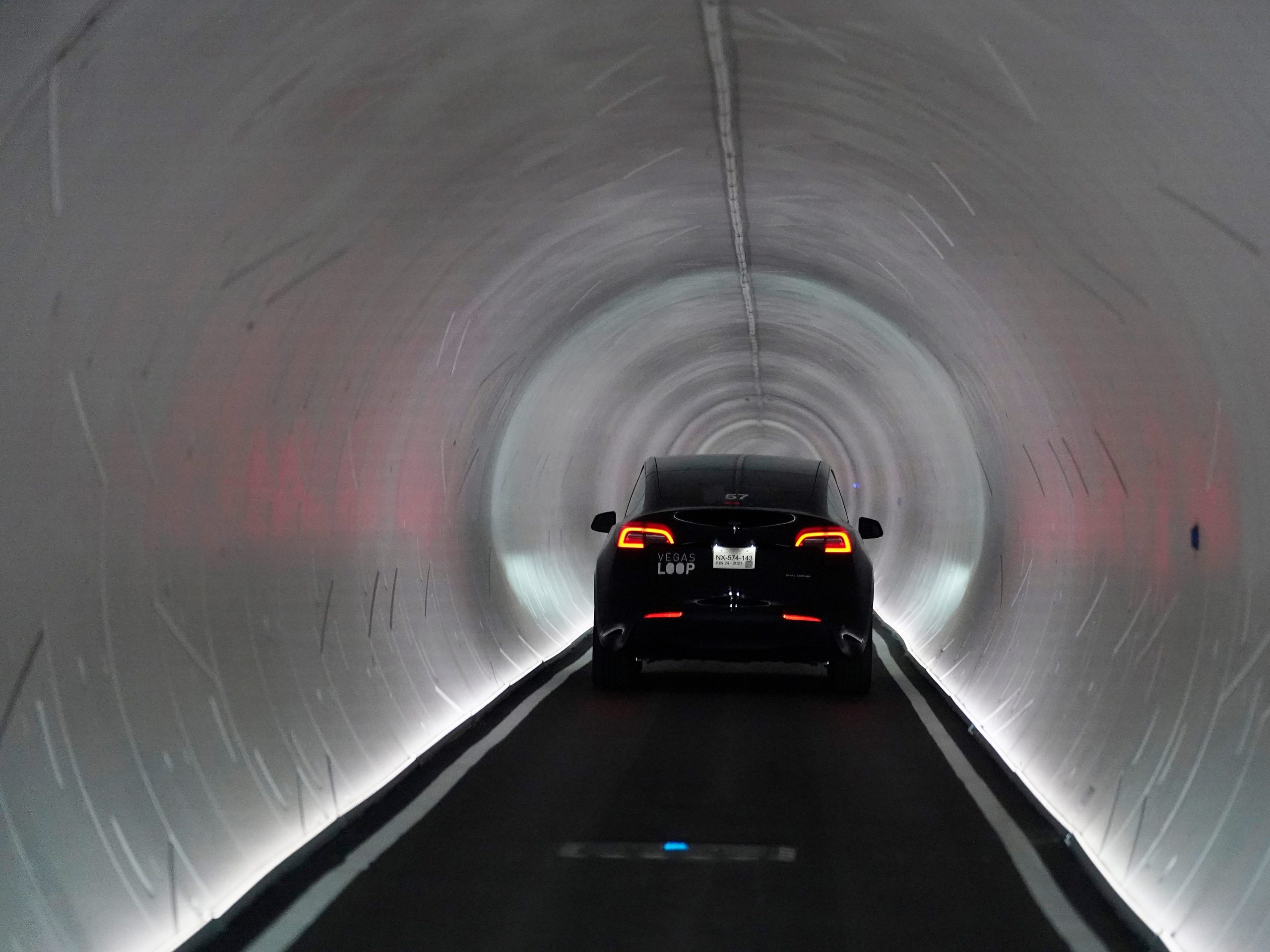 A Tesla vehicle drives into a round tunnel made by The Boring Company in Las Vegas