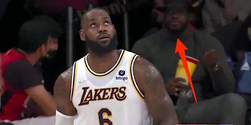 Screenshot shows LeBron James looking up on the court, with a lookalike behind him in the stands.