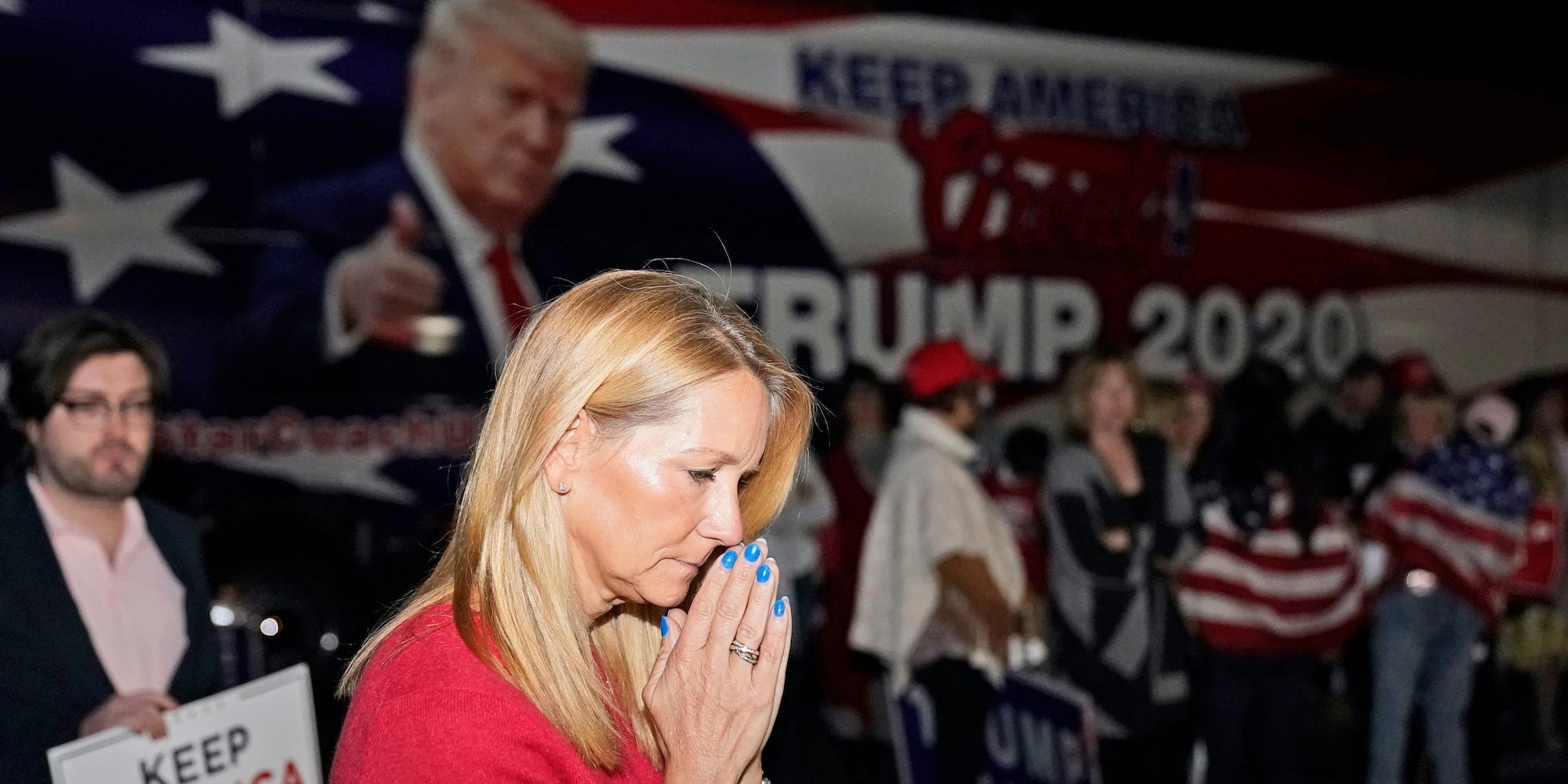 Lori Gibson, of Atlanta, listens to a speech by President Donald Trump prior to a press conference with Donald Trump Jr., at Georgia Republican Party Headquarters Thursday, Nov. 5, 2020 in Atlanta