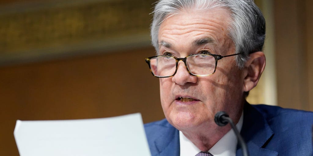 Jerome Powell reads document while speaking in front of the Senate.
