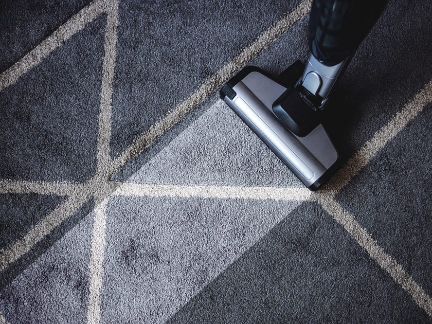 Close up of steam cleaner cleaning very dirty carpet.