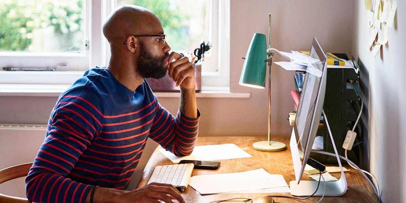 man using computer in home office