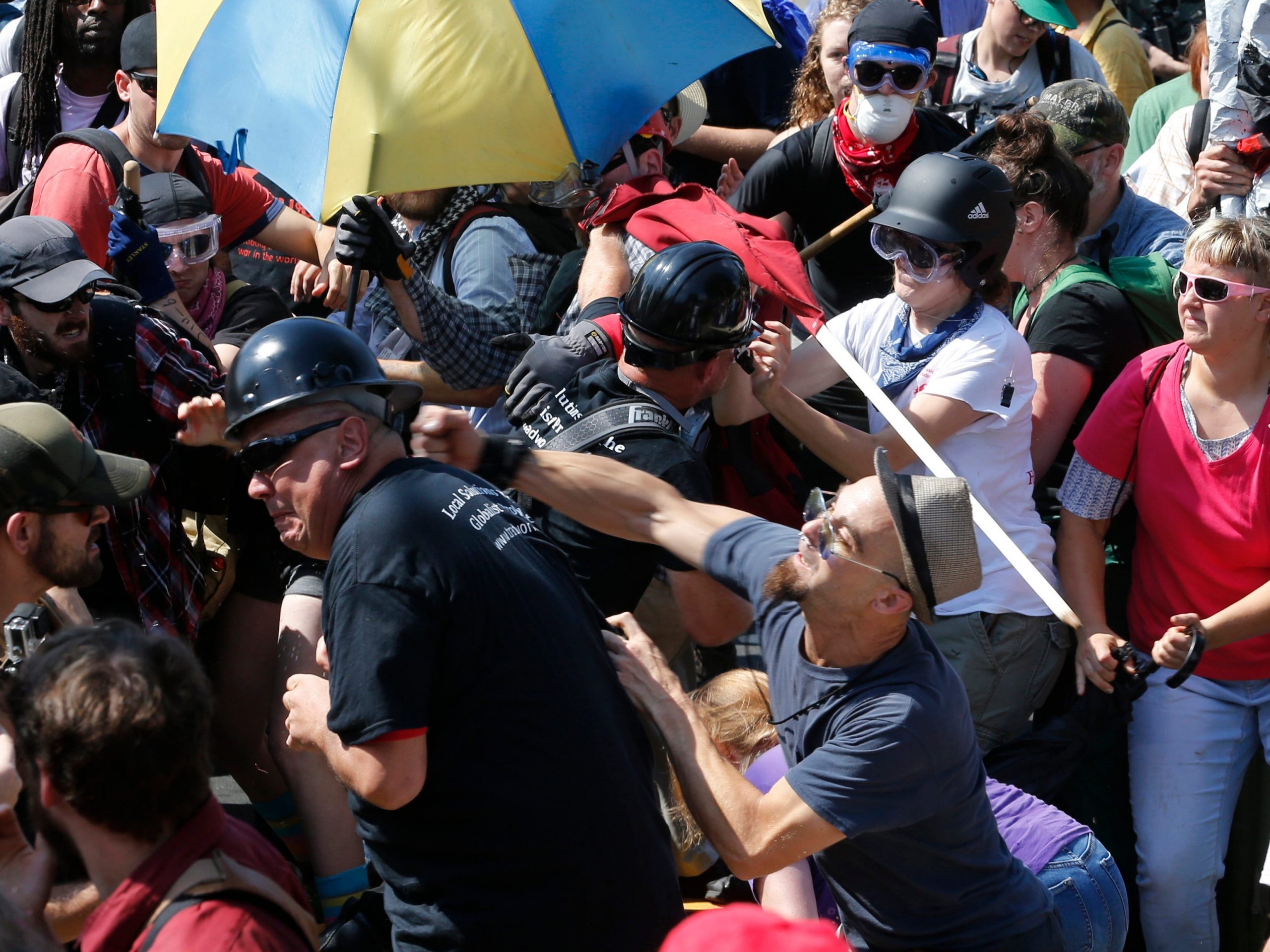 White nationalist demonstrators clash with counter demonstrators at the entrance to Lee Park in Charlottesville, Virginia on August 12, 2017.