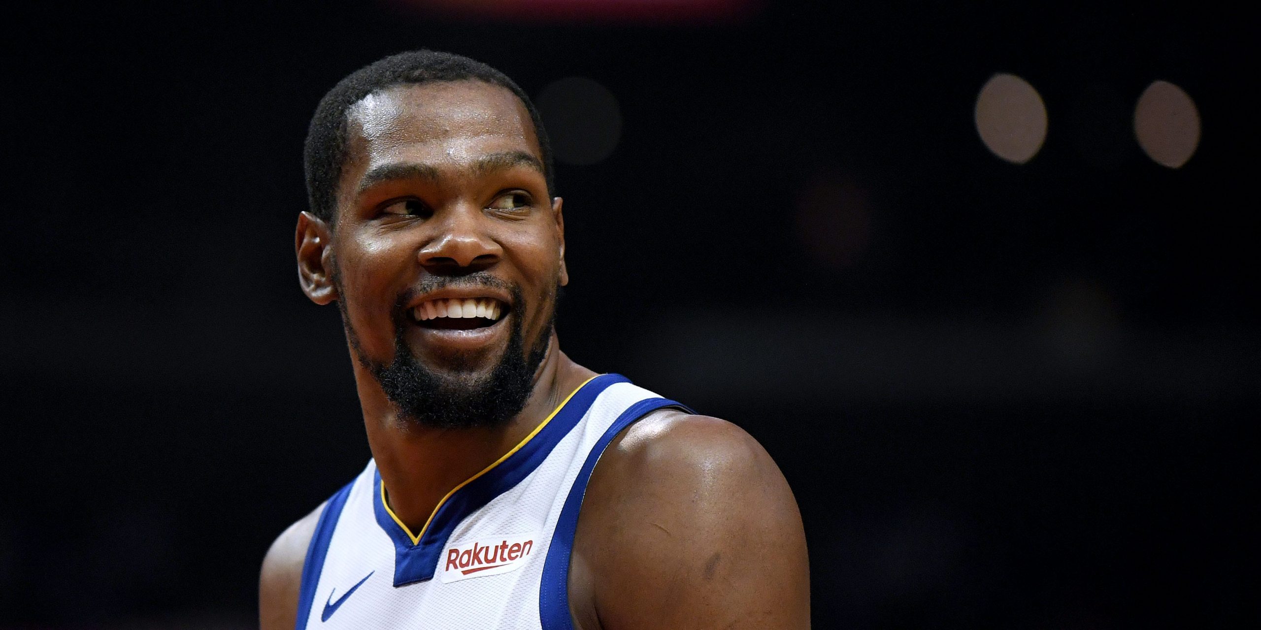 Kevin Durant smiles during a Golden State Warriors game in 2019.