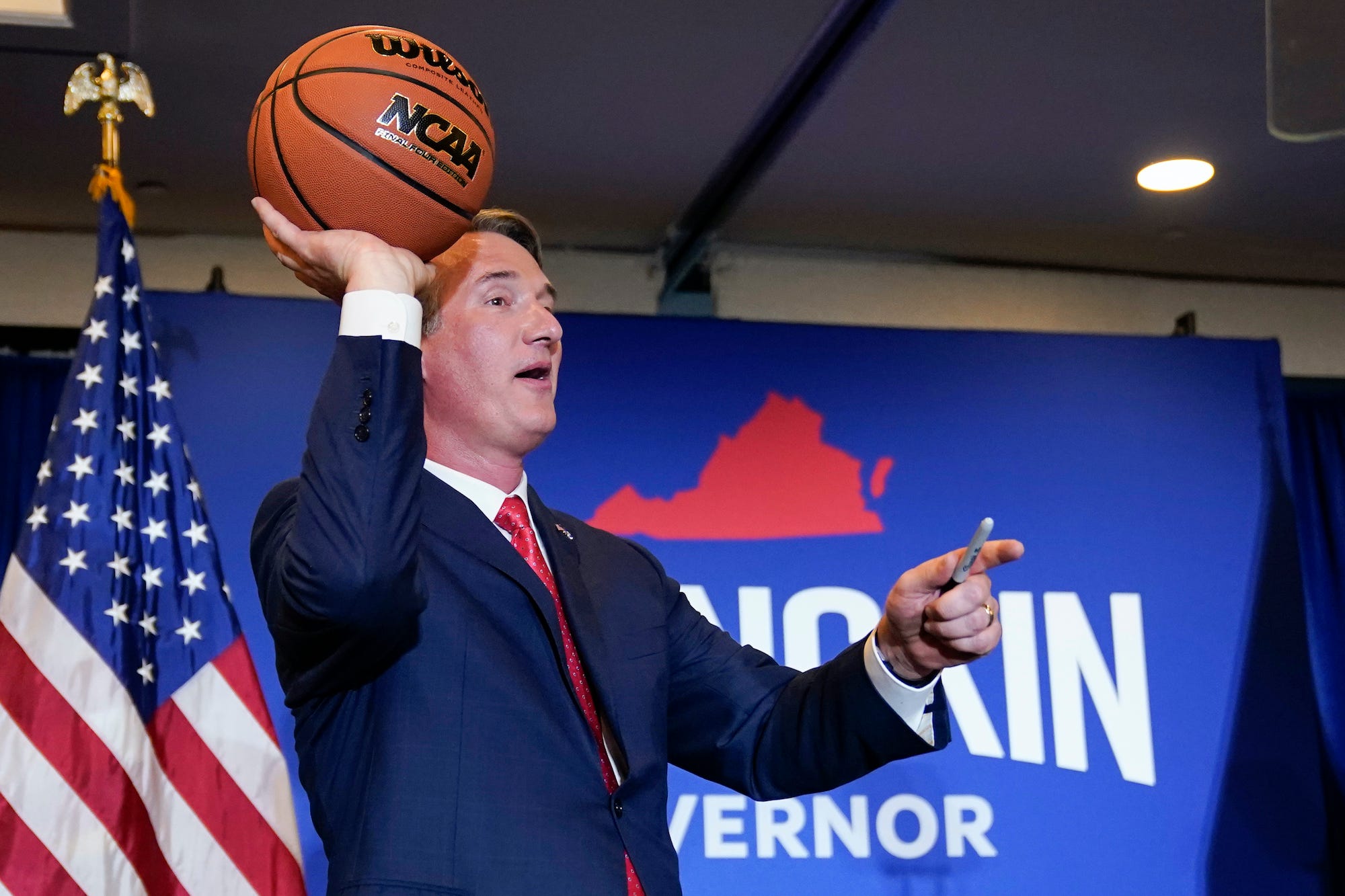 Virginia Gov.-elect Glenn Youngkin tosses a signed basketball to supporters at an election night party in Chantilly, Va., early Wednesday, Nov. 3, 2021, after he defeated Democrat Terry McAuliffe.