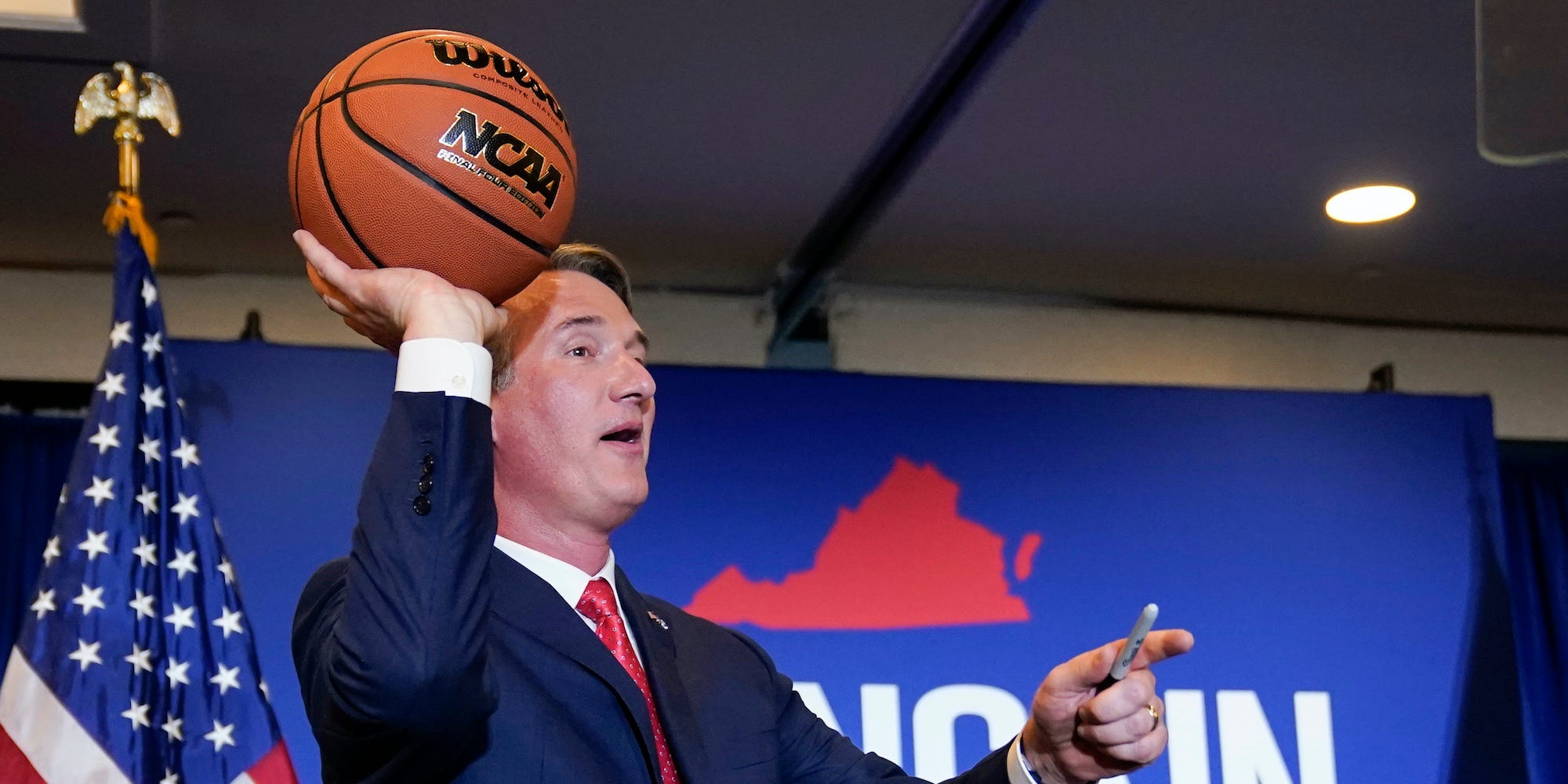 Virginia Gov.-elect Glenn Youngkin tosses a signed basketball to supporters at an election night party in Chantilly, Va., early Wednesday, Nov. 3, 2021, after he defeated Democrat Terry McAuliffe.