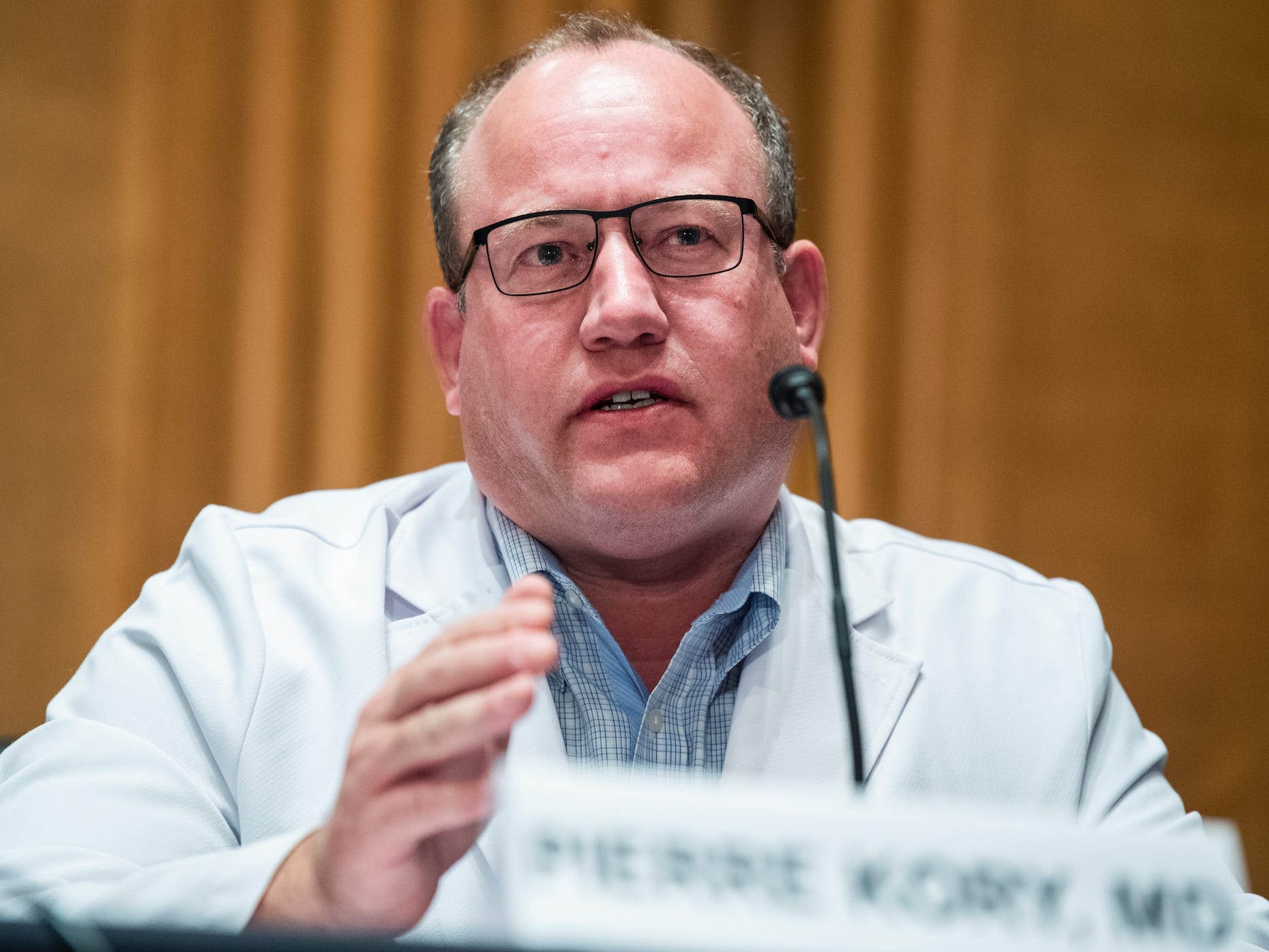 Dr Pierre Kory sits in front of a microphone, testifying before members of the US Senate.