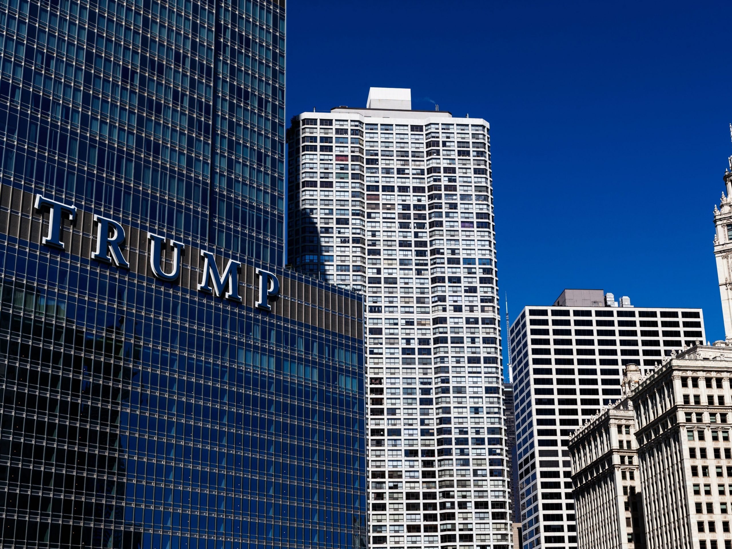 The glassy facade of Trump Tower in Chicago next to older brick buildings