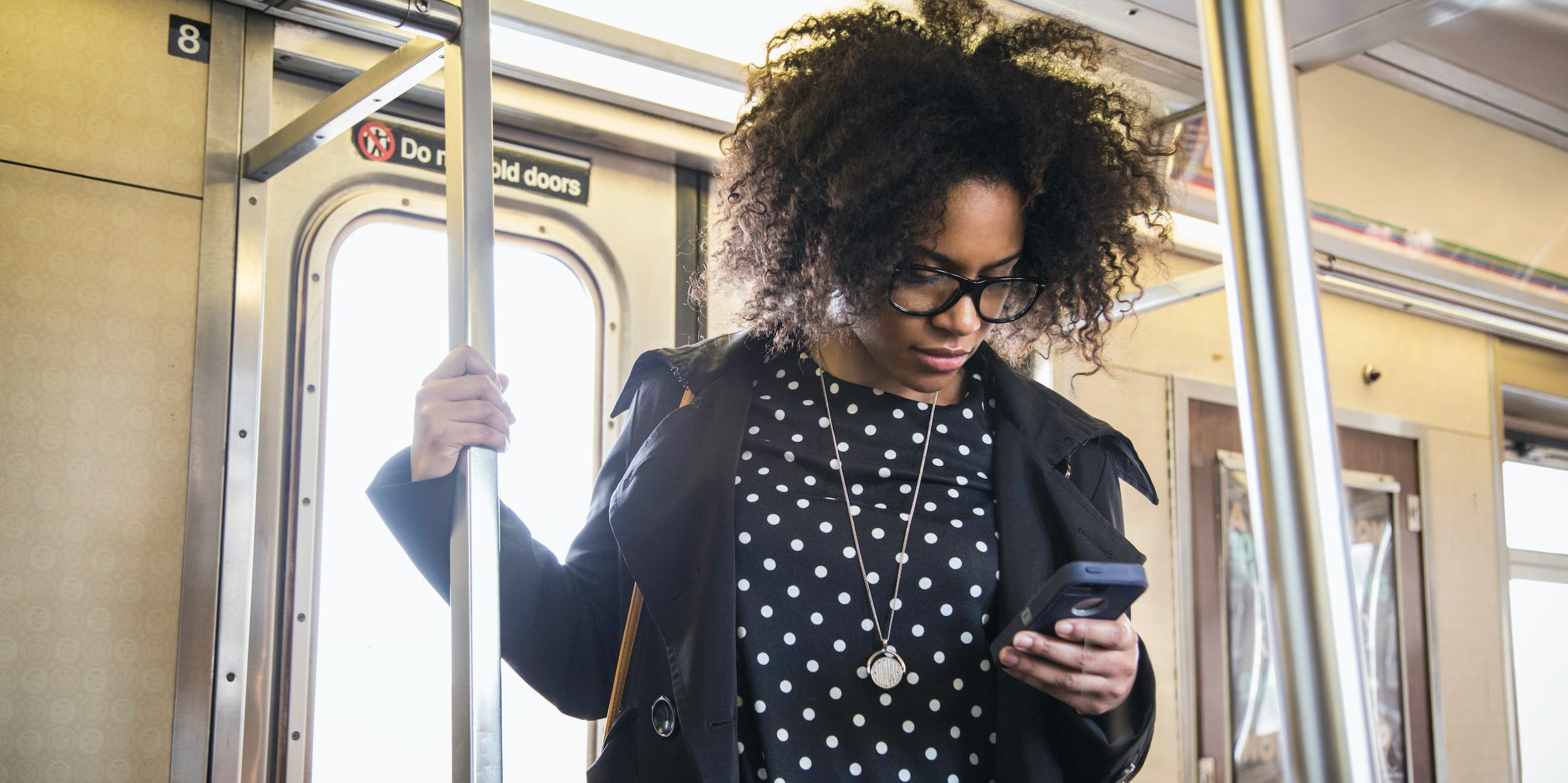 commuter on train looking at phone