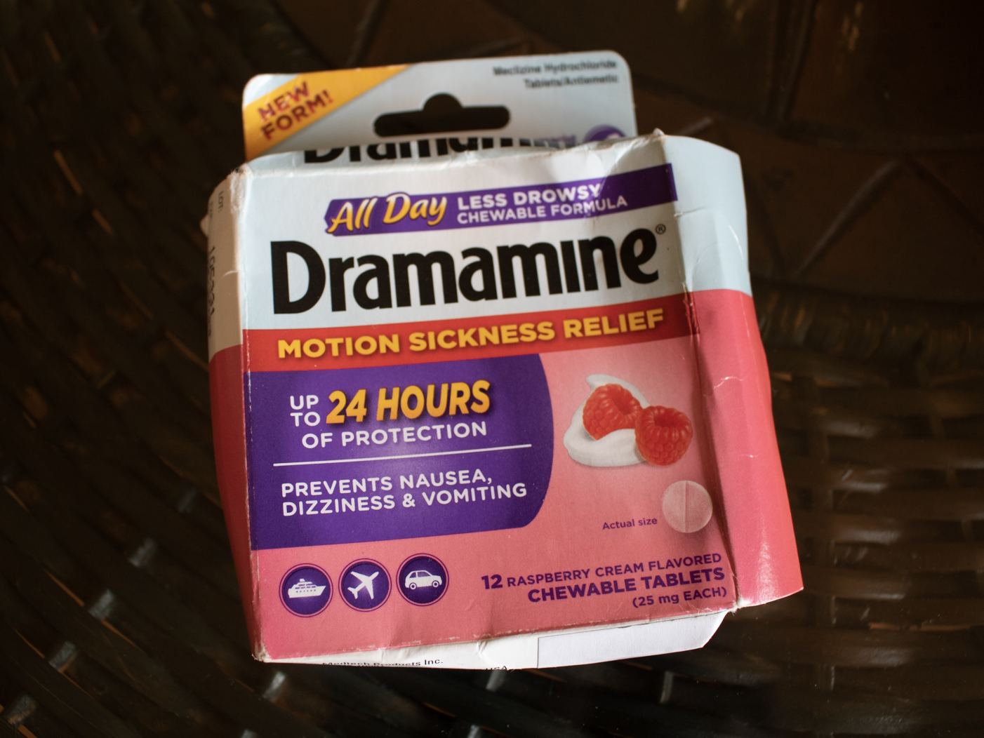 A of Dramamine in pink and white box on a brown table