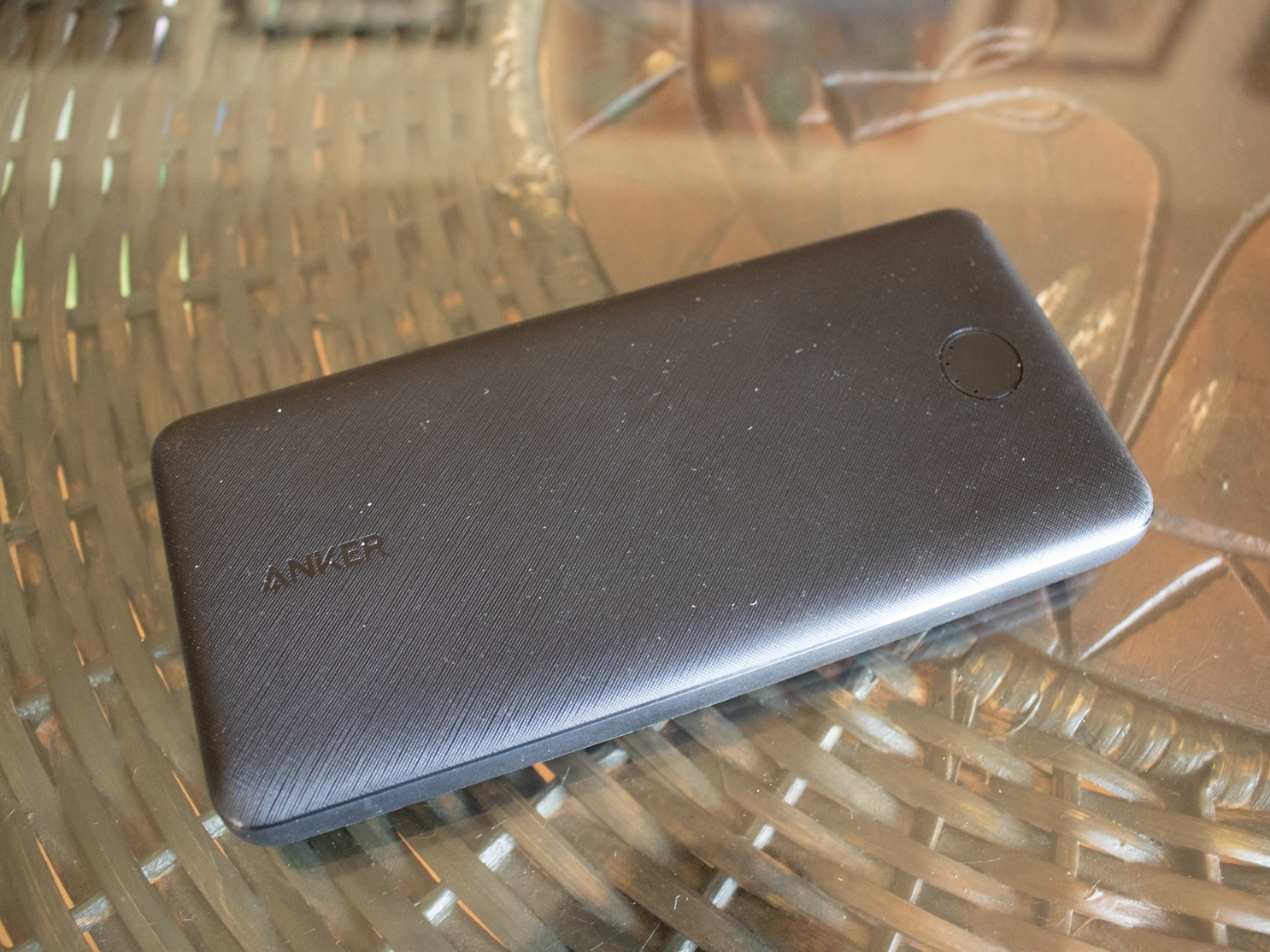 Rectangular black portable charger on brown table