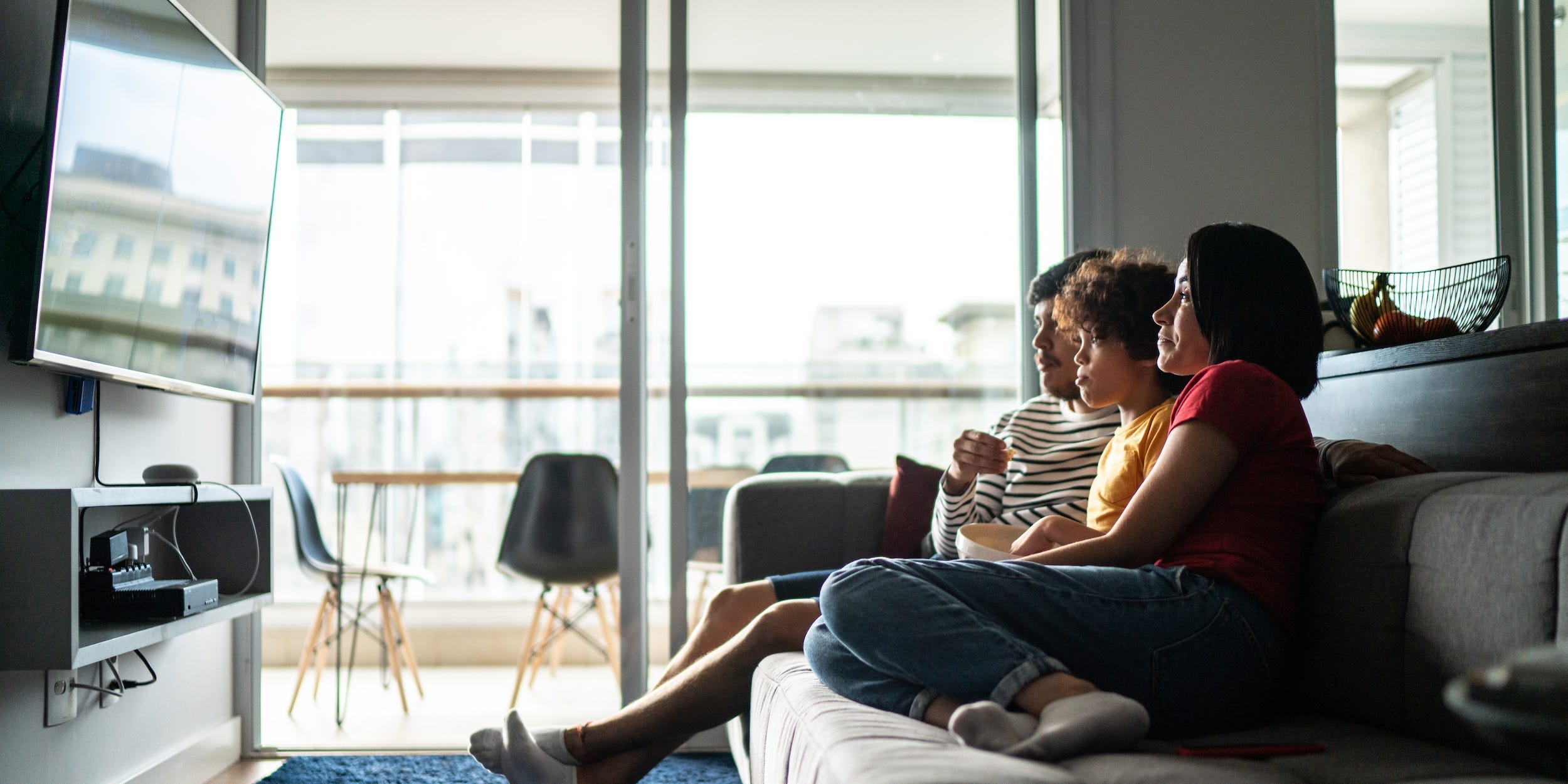 family watching tv on couch at home