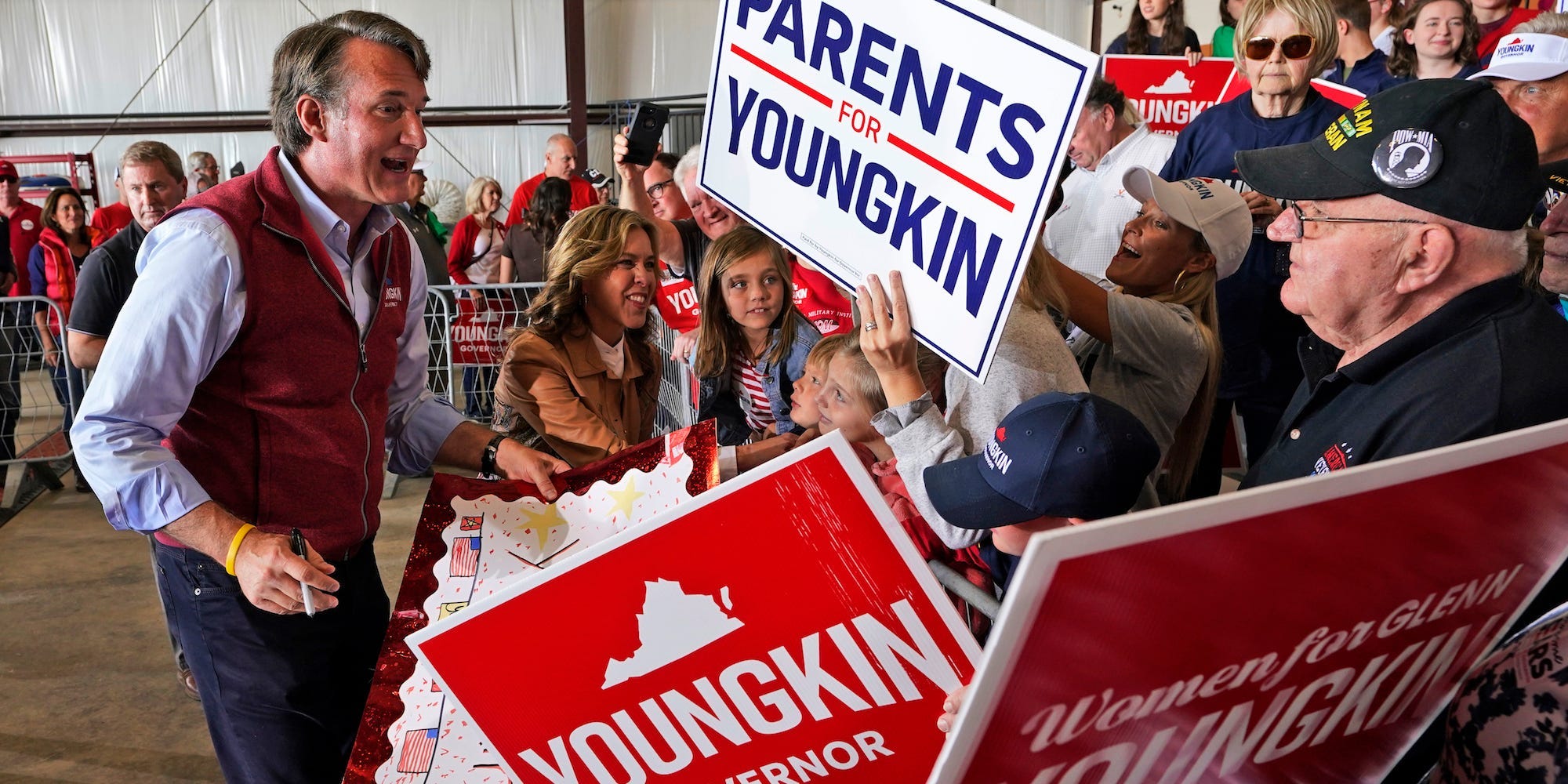 Republican gubernatorial candidate Glenn Youngkin , left, and his wife Suzanne, second from left, greet supporters during a rally in Chesterfield, Va., Monday, Nov. 1, 2021.