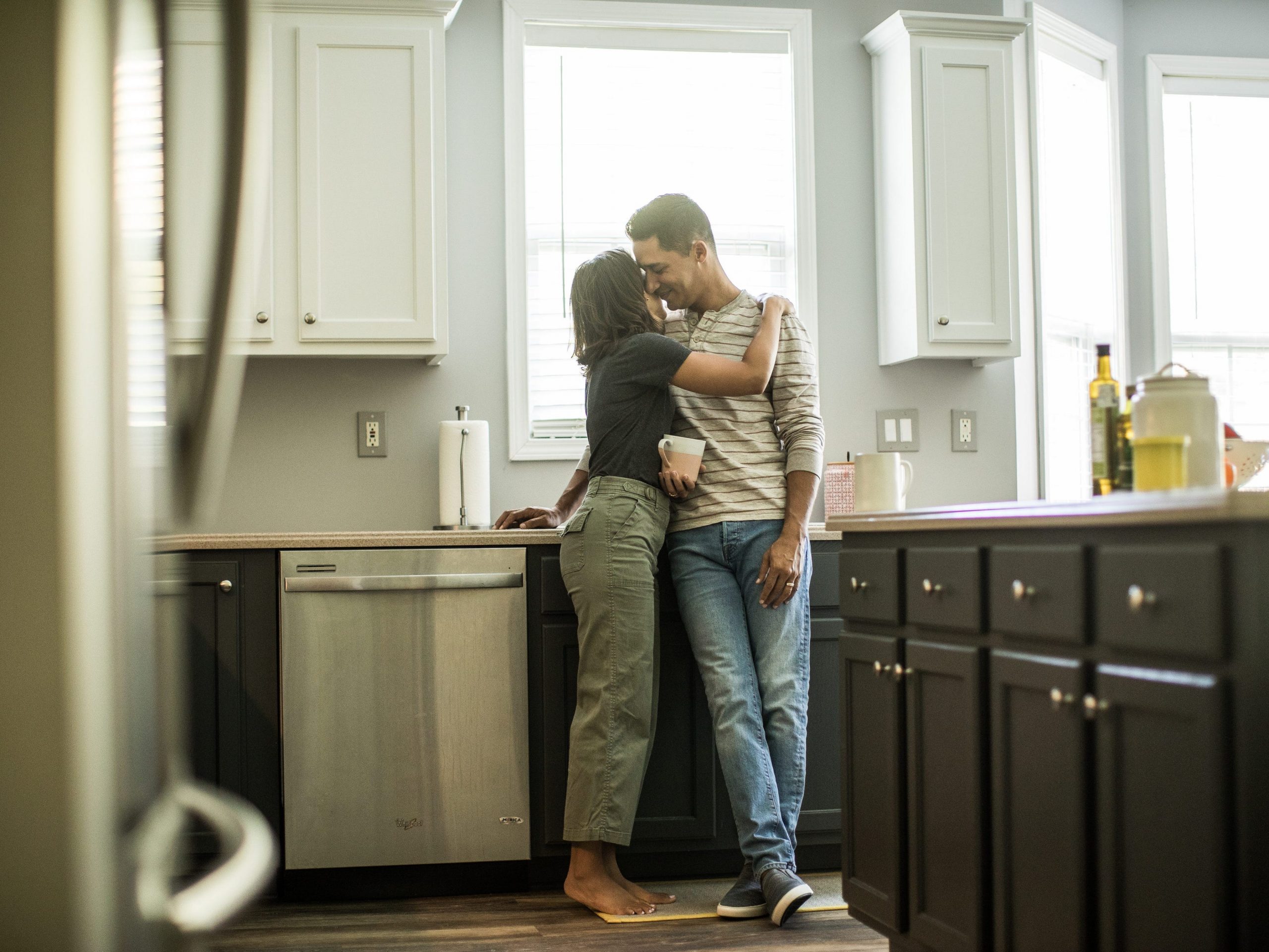 Husband and wife talking in kitchen