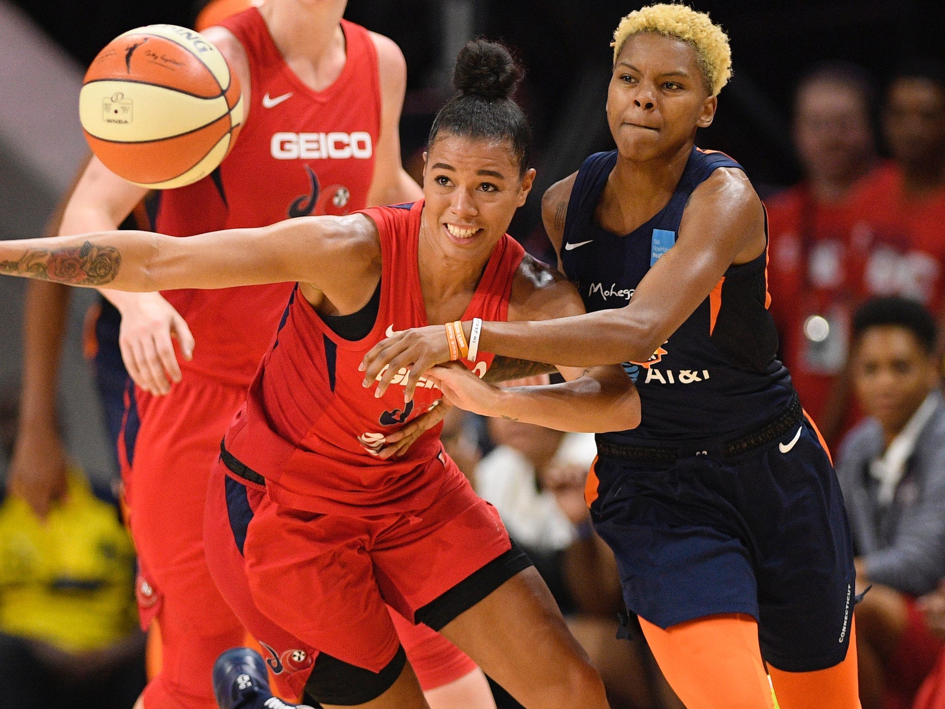 Natasha Cloud (left) and Courtney Williams battle for a loose ball.