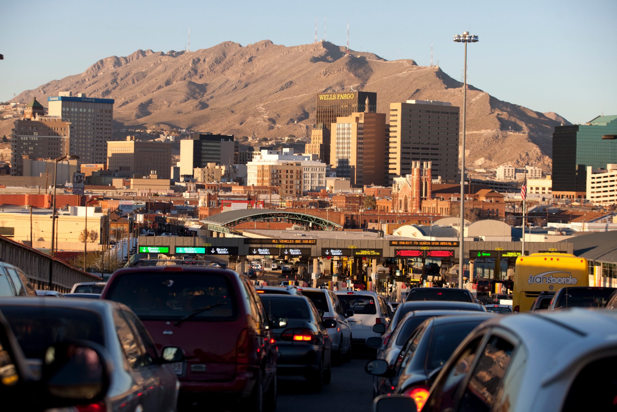 Cars pack a road toward a hill.