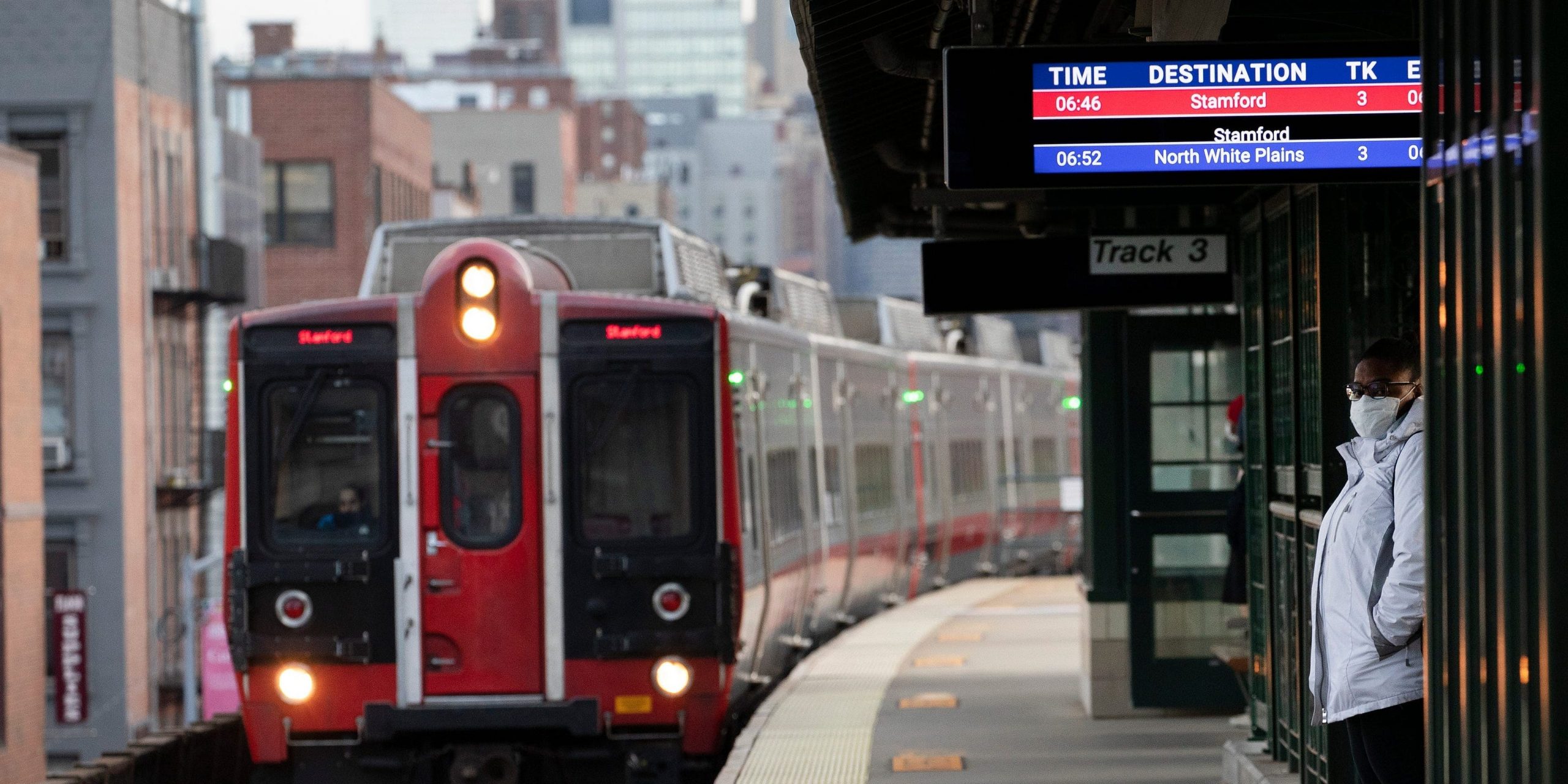 A woman waits for a train on a Metro-North Railroad platform at the 125th Street station.