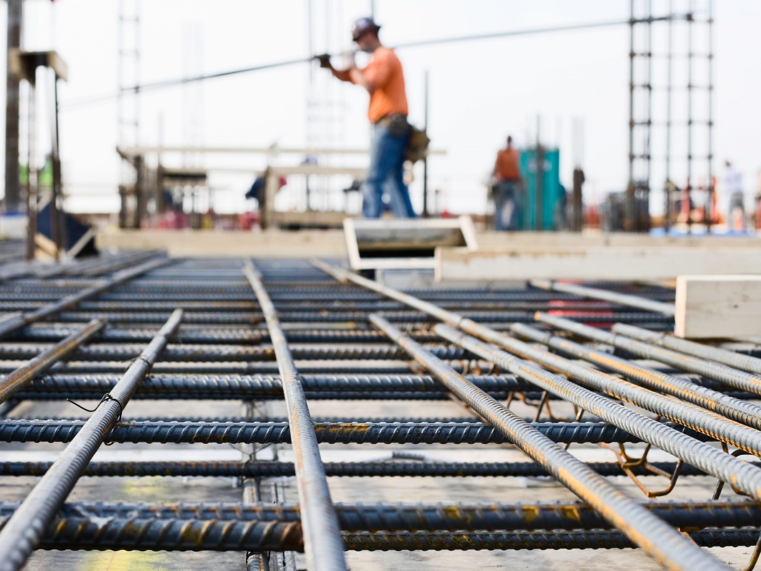 Ironworker prepping rebar for poured concrete floor. This rebar infrastructure will form the support for the concrete floor. This high rise will eventually be 35 stories high; the picture was taken on the ninth floor.