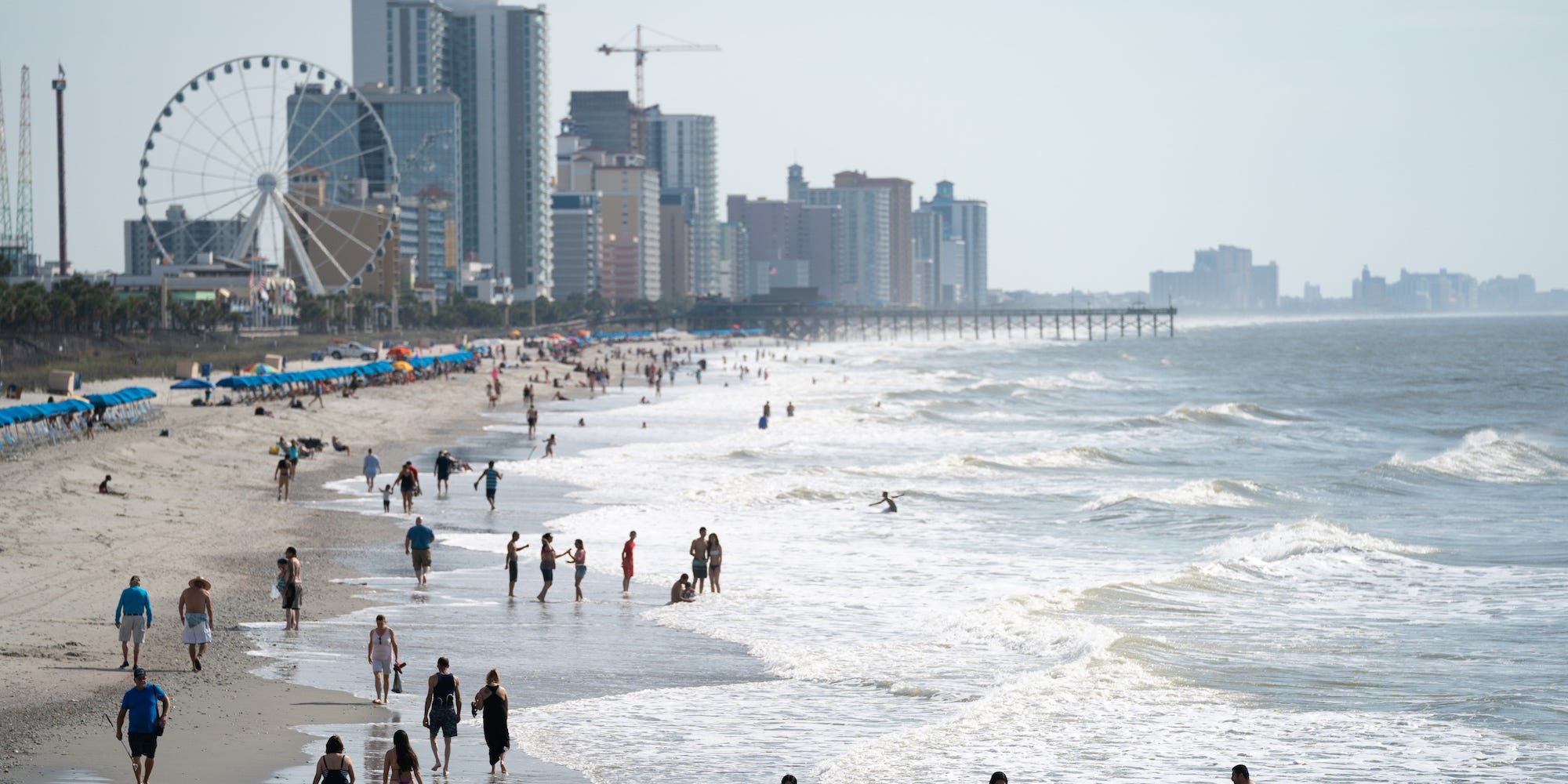 People walk along the beach the morning of May 29, 2021 in Myrtle Beach, South Carolina.