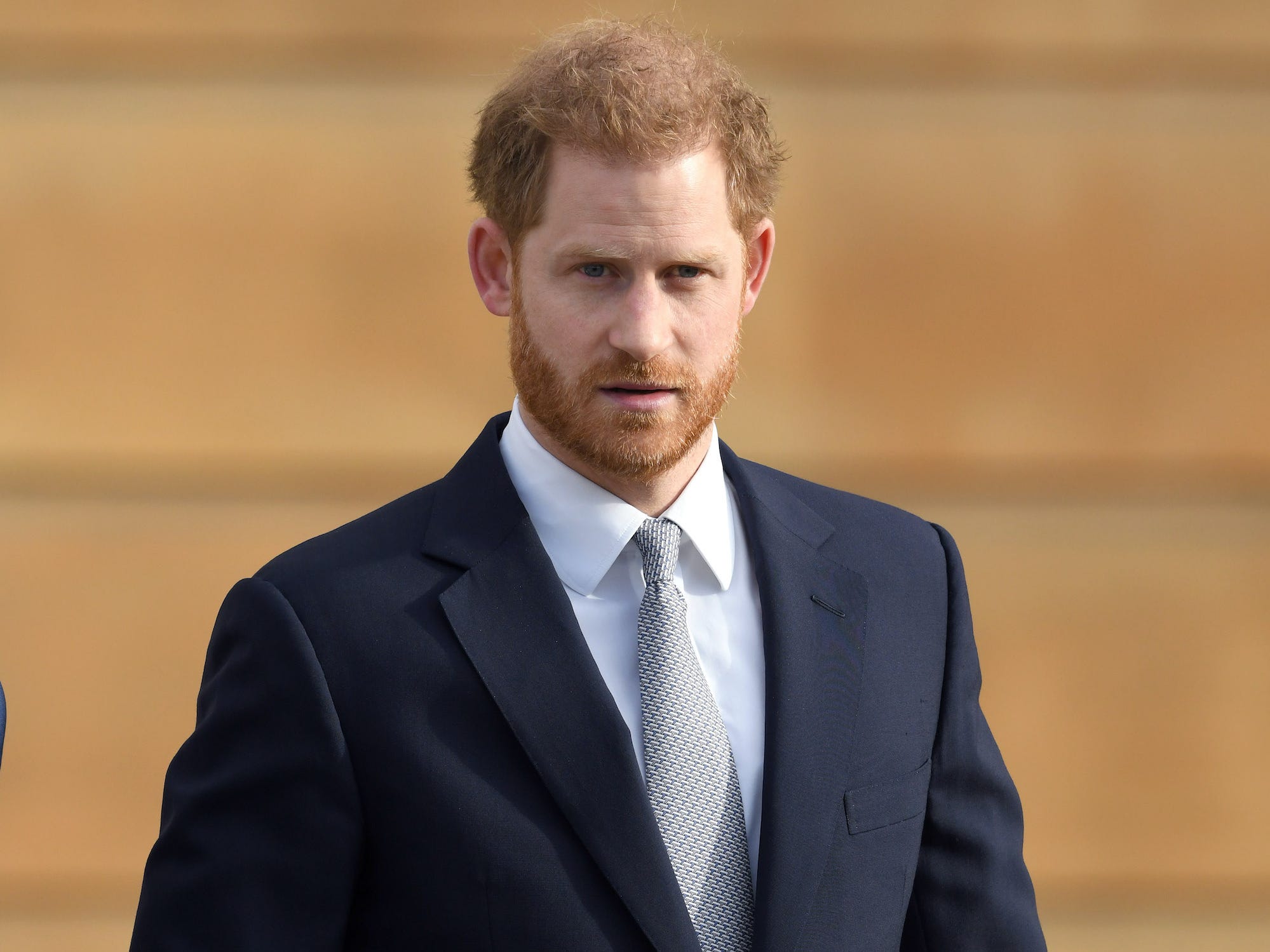 A photo of Prince Harry walking.