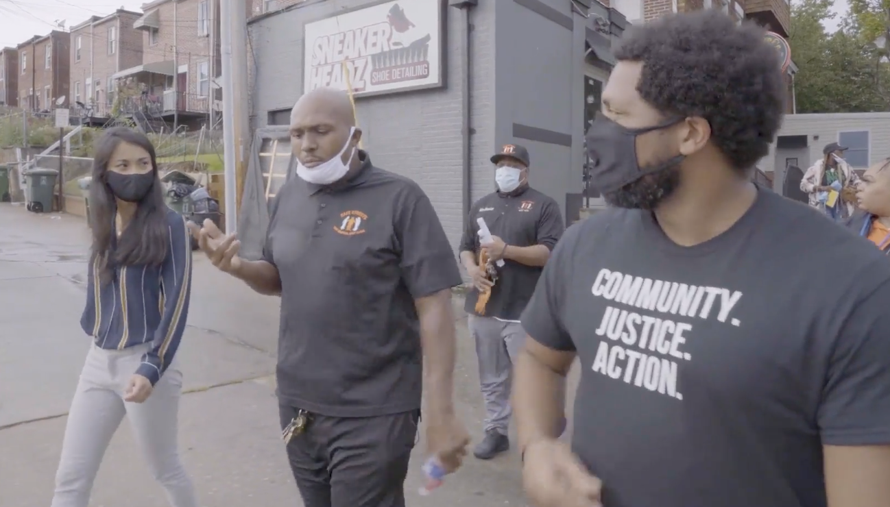 Activists Dante Barksdale of Safe Streets and Gregory Jackson of the Community Justice Action Fund walk through Baltimore.