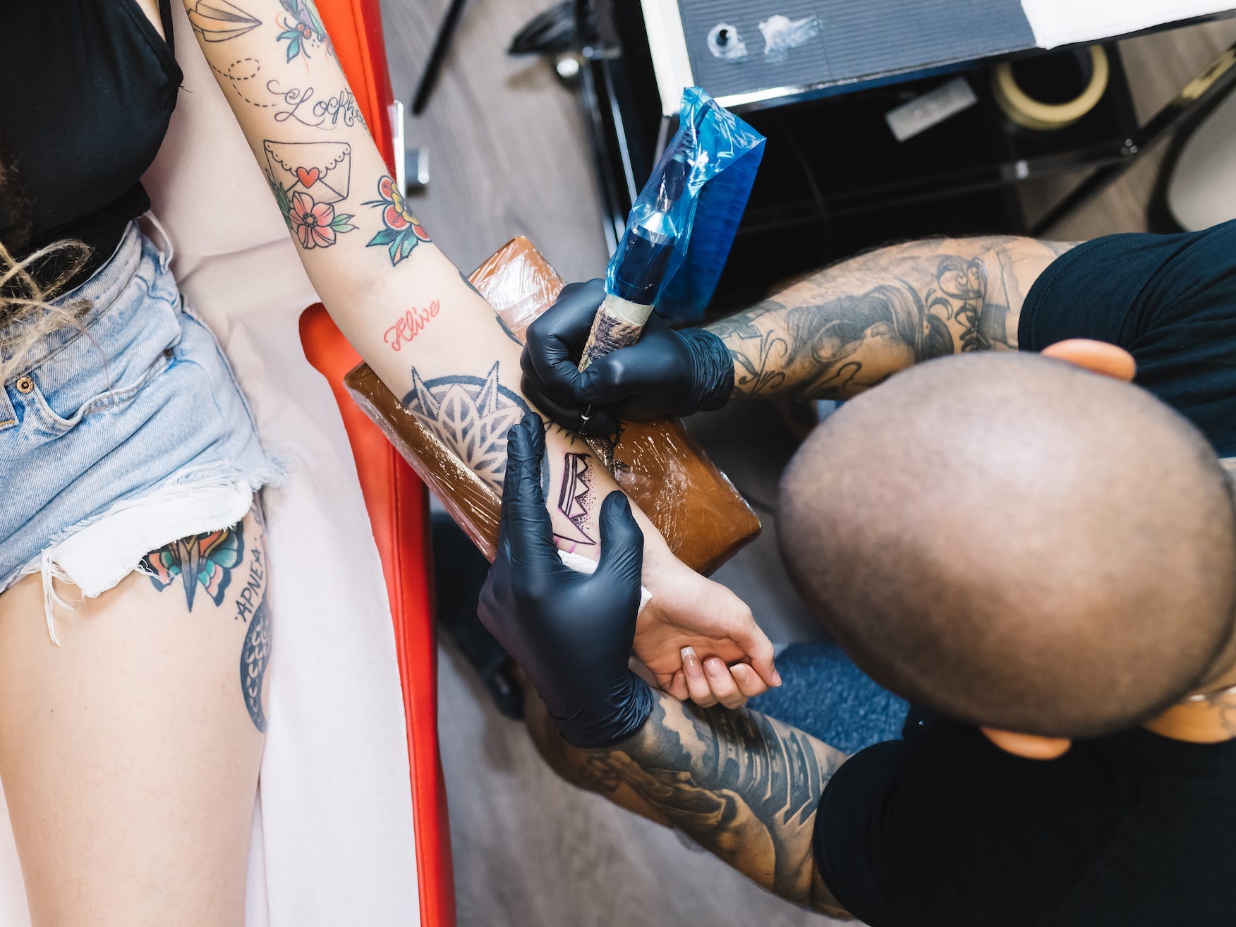 A person gets a tattoo on their arm.