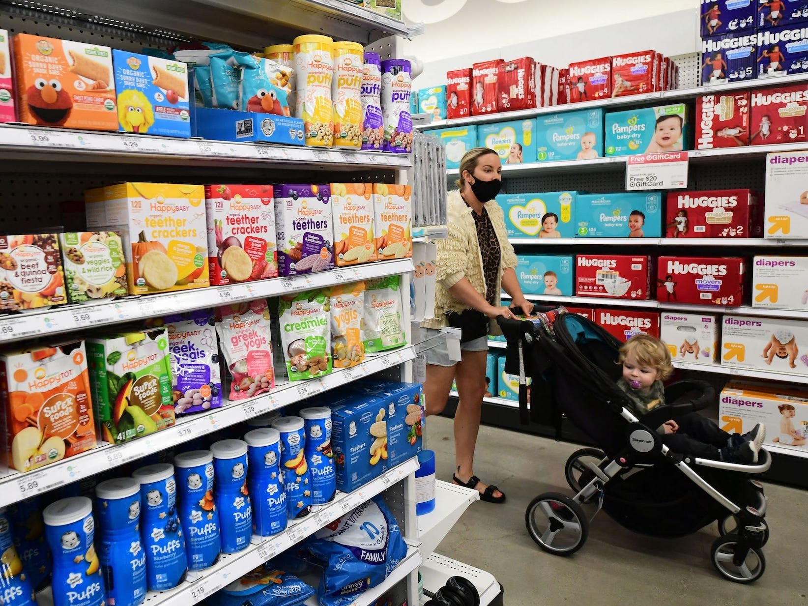 Millennial woman shops with baby at Target