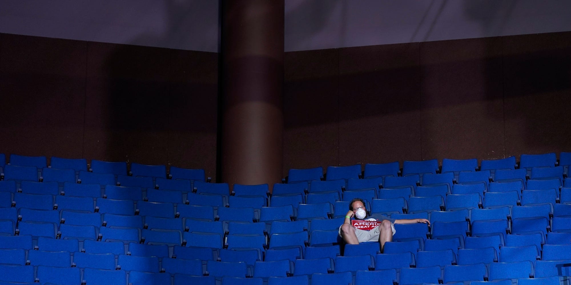 In this June 20, 2020, file photo, a supporter of President Donald Trump sits in the stands wearing a face mask during a campaign rally at the BOK Center in Tulsa, Okla.