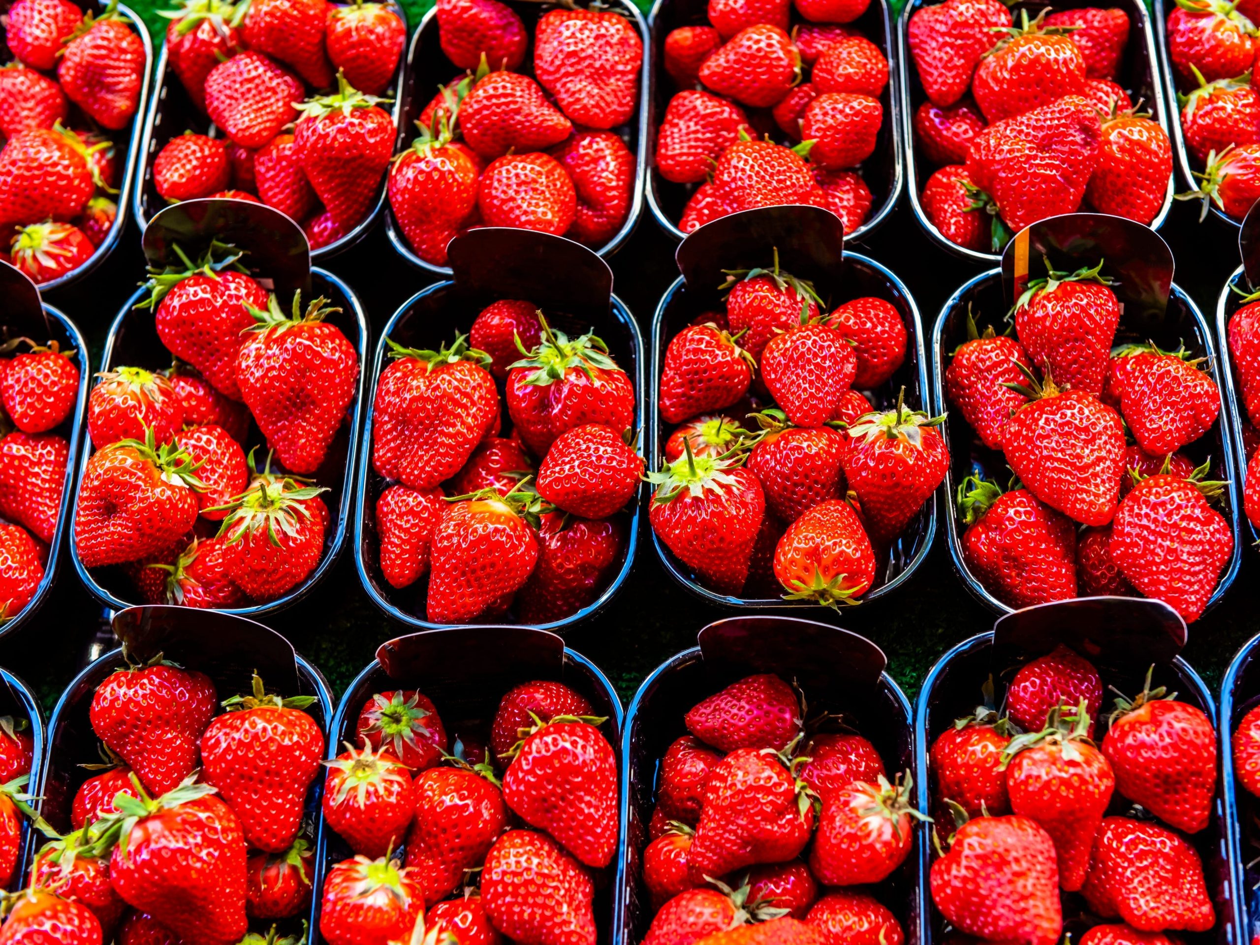 Strawberries for sale at Rue Cler street market, Paris, France.