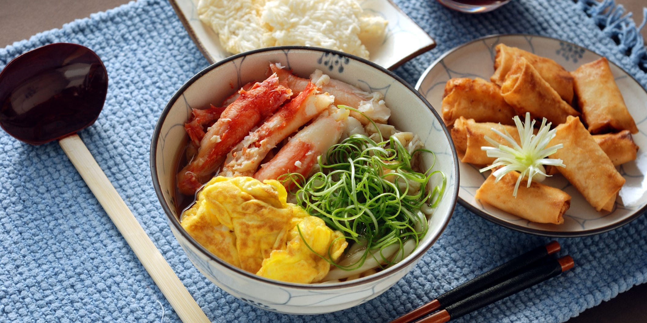 Bowl of crab, eggs, and seaweed paired with rice and tofu.