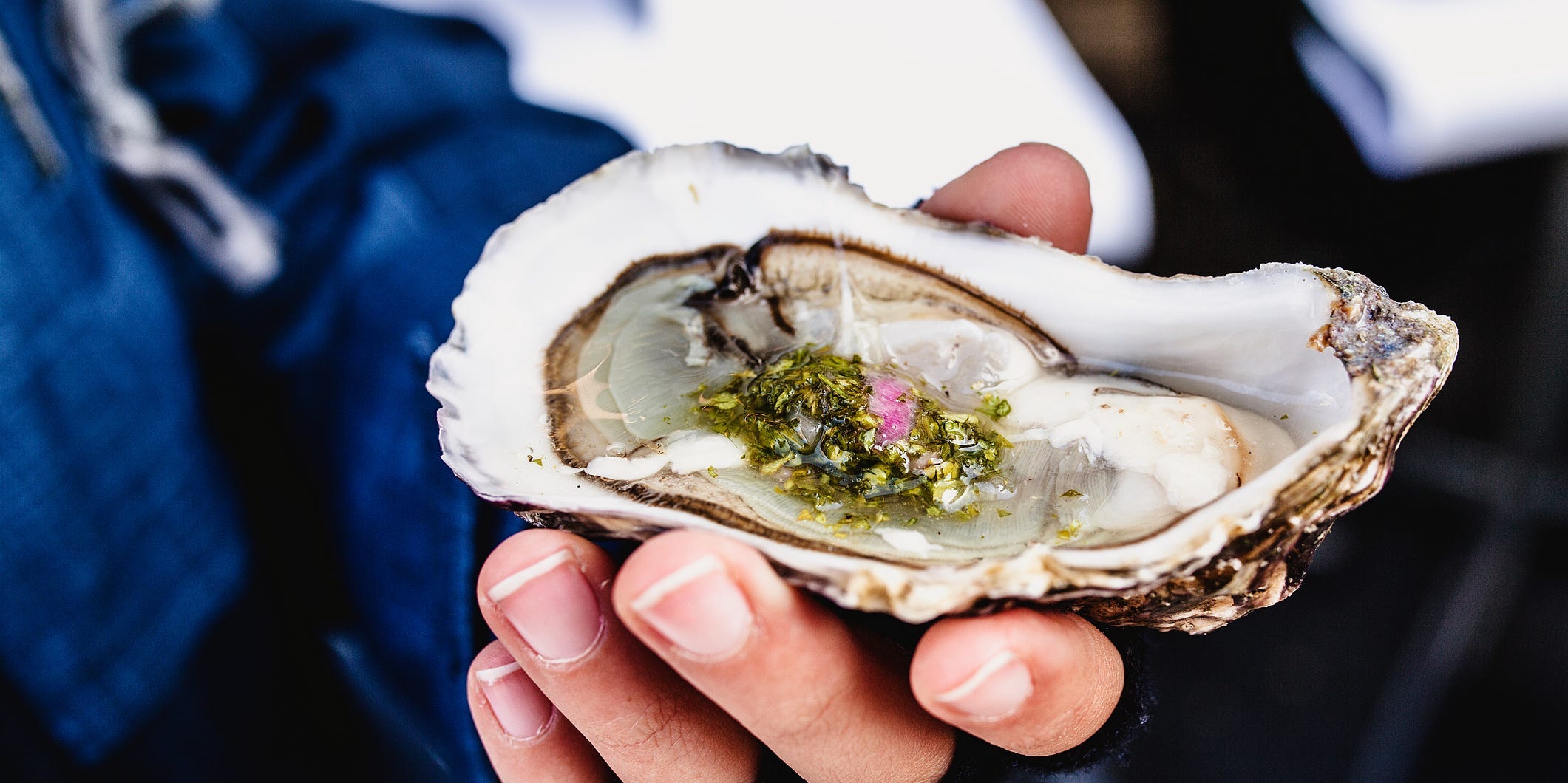 hand holding oysters