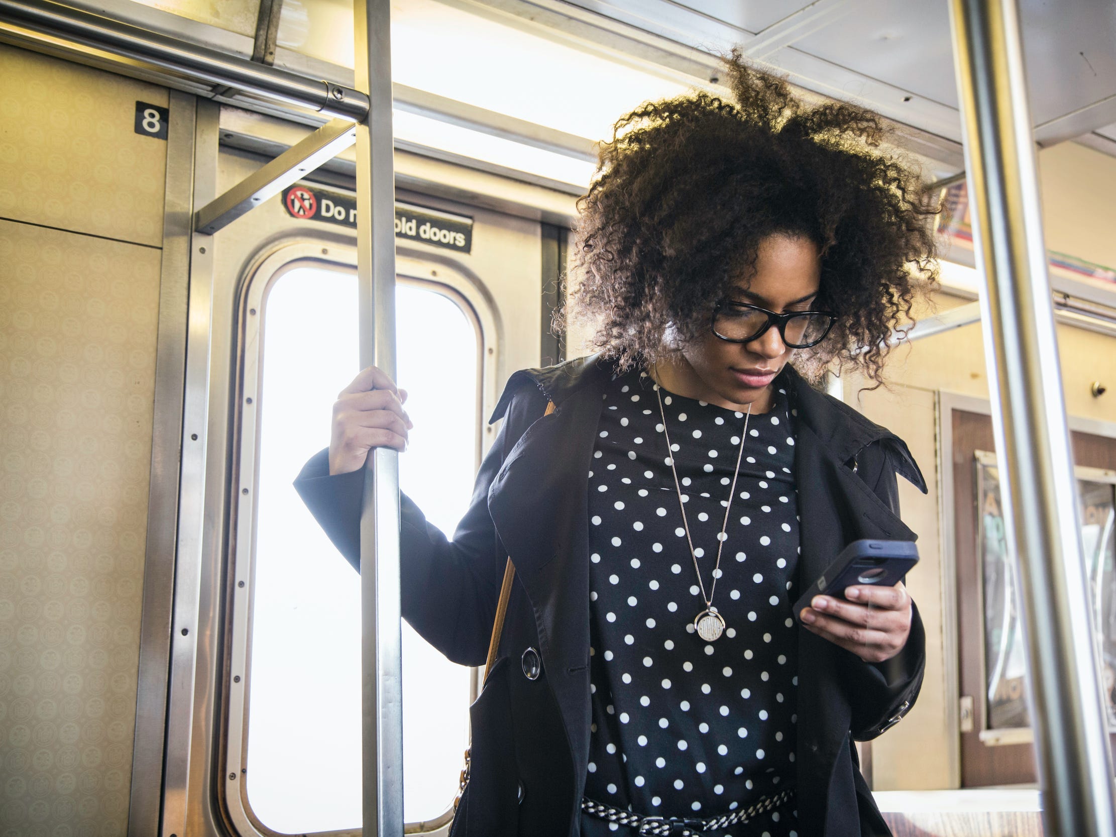 commuter on train looking at phone