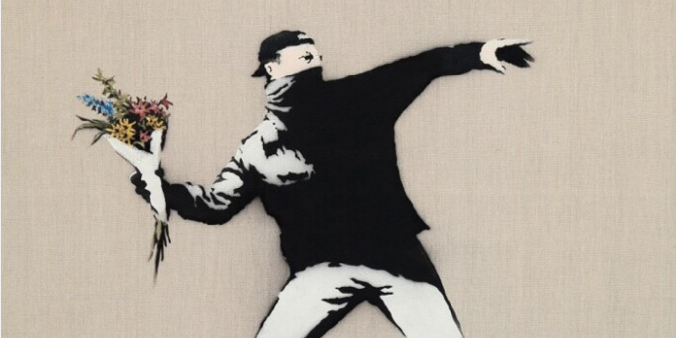 Artist Bansky's "Love Is In The Air" is a stenciled depiction of a young man about to throw a flower bouquet.