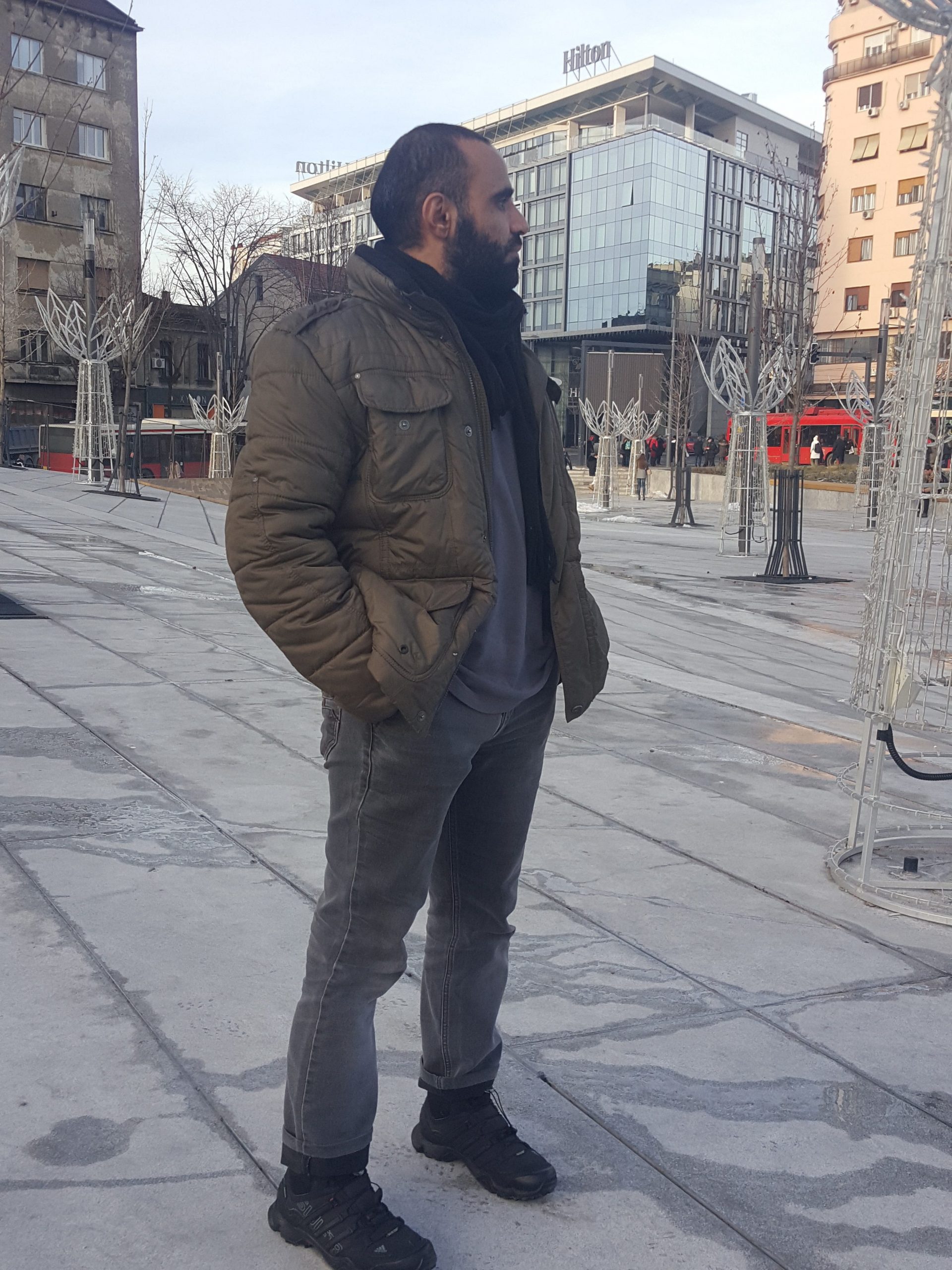 Mansoor Adayfi stands on a street in Belgrade
