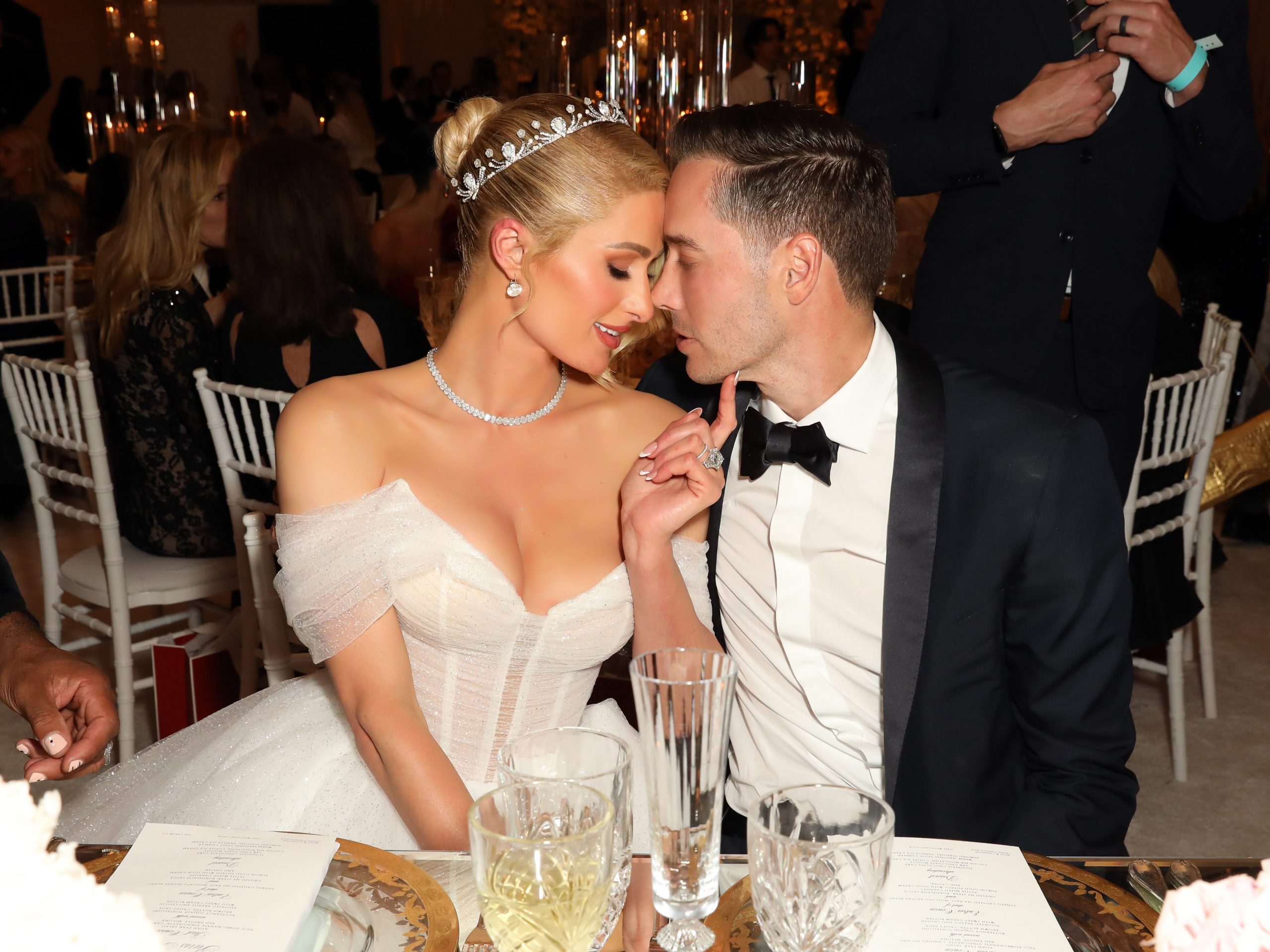 Paris Hilton and Carter Reum lean their heads together on their wedding day.