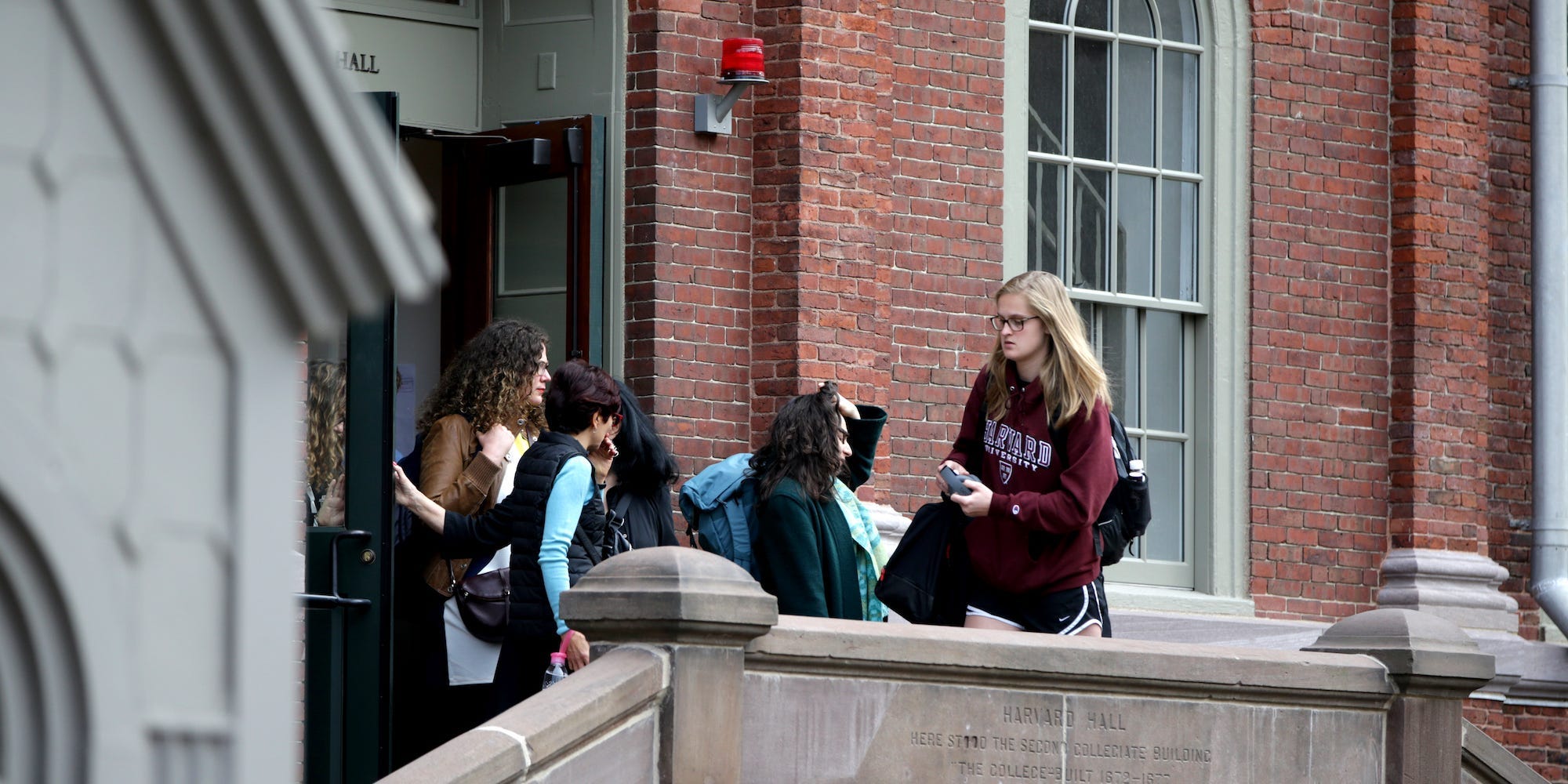 Students emerge from Harvard University's Harvard Hall in Cambridge, MA on March 10, 2020.