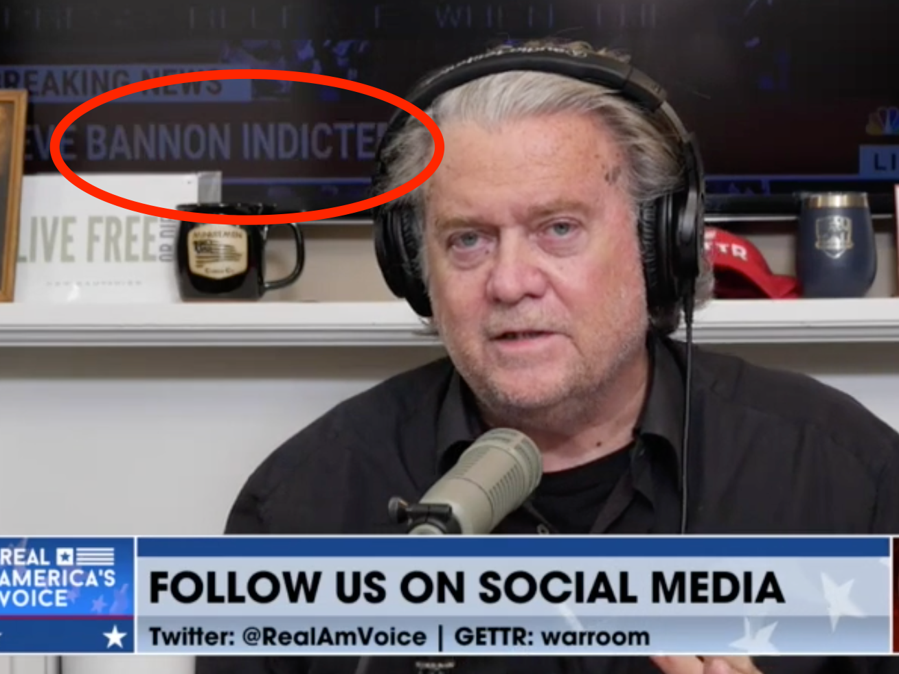 'Bannon indicted' chyron appears behind Steve Bannon on the War Room podcast
