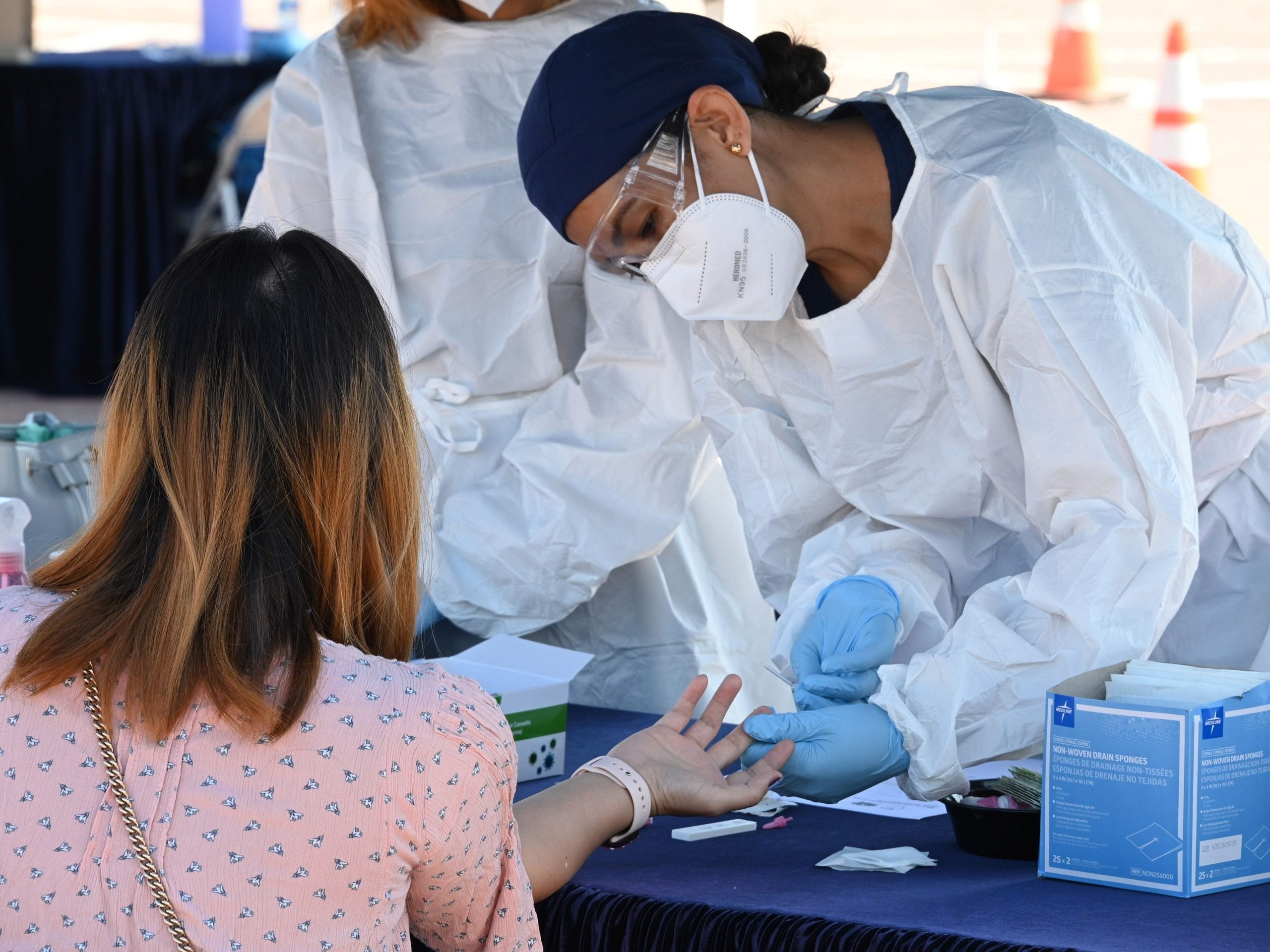 A person undergoes a finger prick blood sample as part of a coronavirus antibody rapid serological test on July 26, 2020 in San Dimas, California, 30 miles east of Los Angeles.