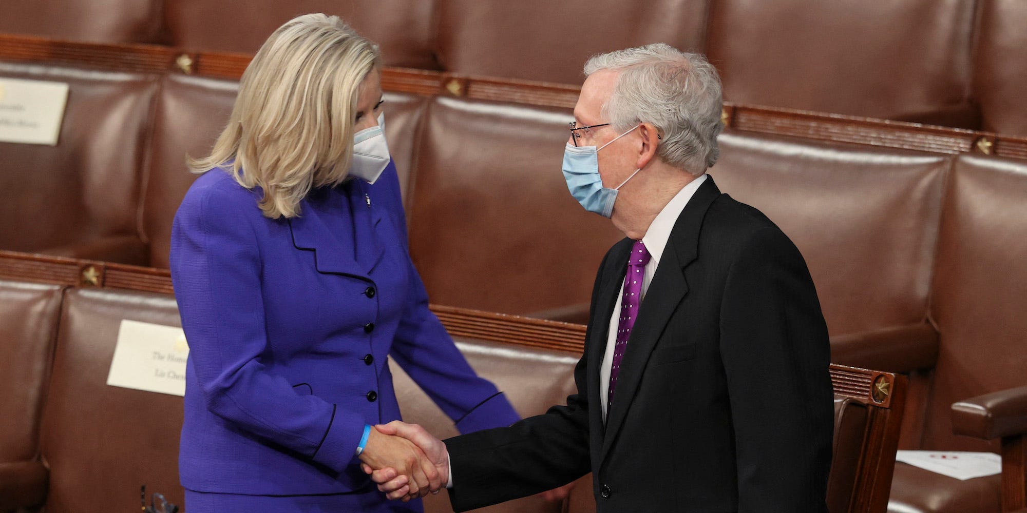 Rep. Liz Cheney shakes hands with Senate Minority Leader Mitch McConnell as they await the start of President Joe Biden's first address to a joint session of Congress on April 28, 2021.