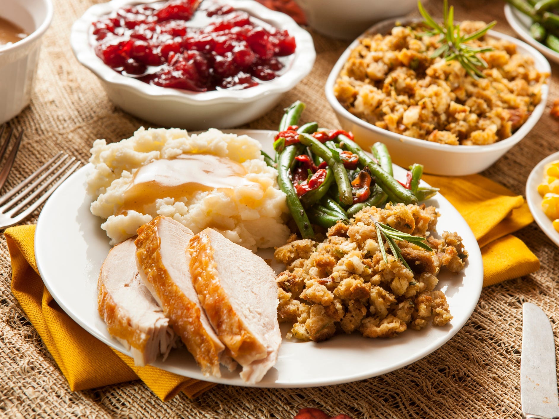 A classic Thanksgiving dinner with spiced turkey, stuffing, mashed potatoes, and green beans