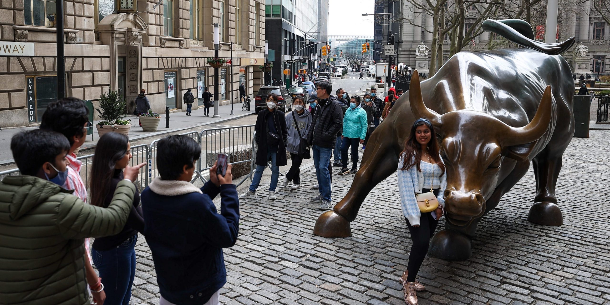 NEW YORK, USA - MARCH 25: Tourists that lined up for take a photo of the Charging Bull are seen during COVID-19 pandemic in New York City, United States on March 25, 2021. (Photo by Tayfun Coskun/Anadolu Agency via Getty Images)