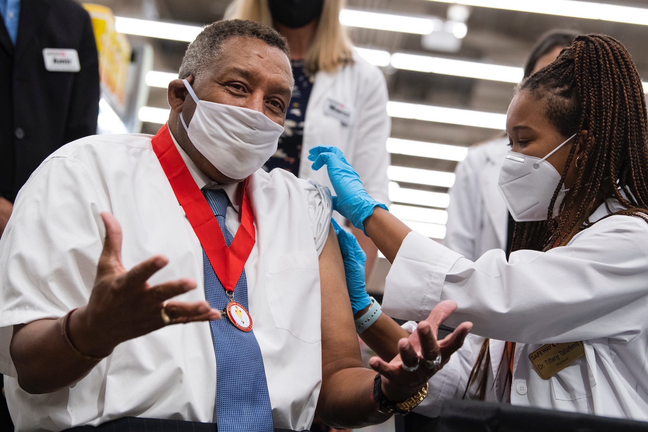 Frank Mallone, 71, receiving his Pfizer COVID-19 vaccine booster shot from Dr. Tiffany Taliaferro at the Safeway on Capitol Hill in Washington, D.C., on Monday, October 4, 2021.