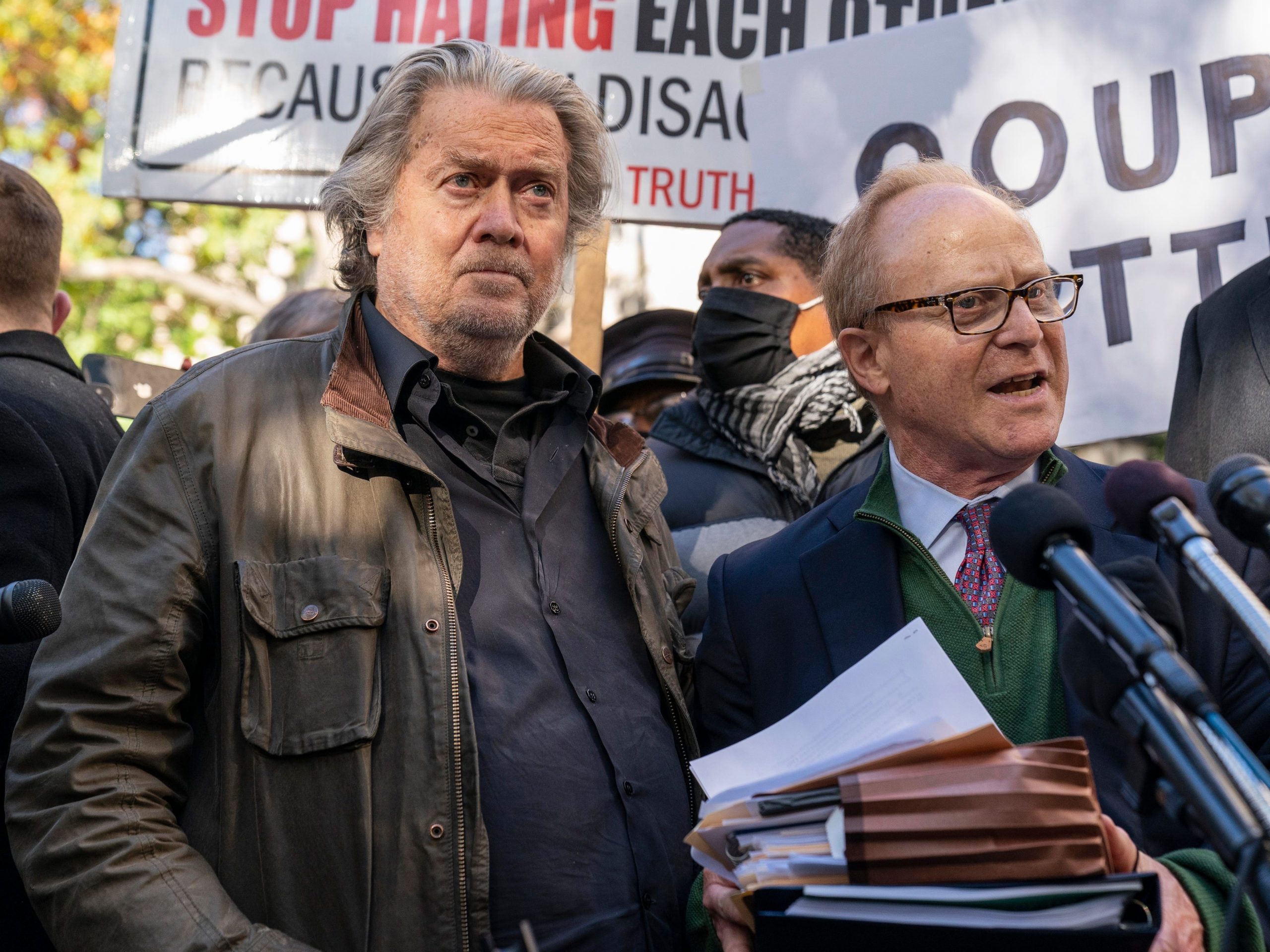 Former White House strategist Steve Bannon, center, and attorney David Schoen, right, pause to speak with reporters after departing federal court, Monday, Nov. 15, 2021, in Washington.