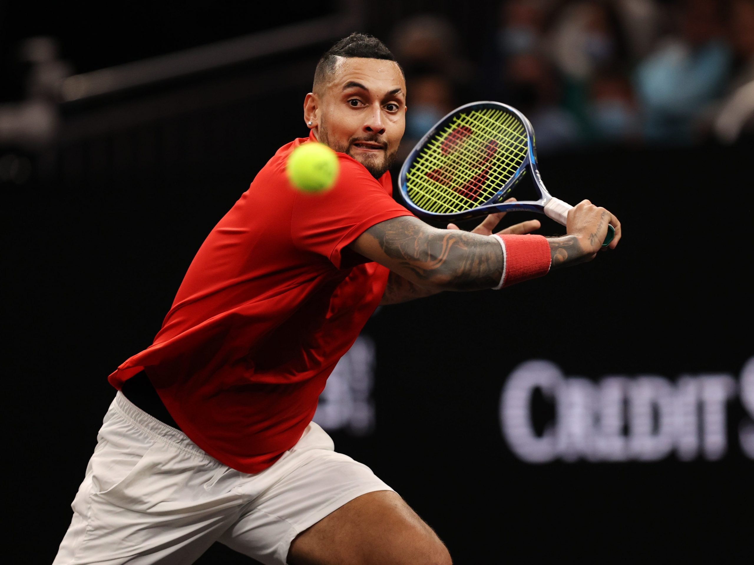 Nick Kyrgios returns a serve.